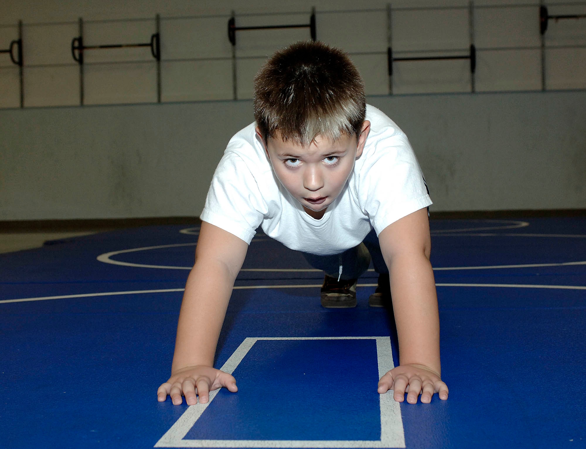 FAIRCHILD AIR FORCE BASE, Wash. – Joshua Heafey, son of Tech. Sgt. Valorie Whitehall, 92nd Maintenance Operation Squadron NCOIC aircraft documentation, shows the definition of “elbow grease” by doing 49 push-ups at the second annual 
push-up-athon at the base fitness center on Dec. 6. The event hosted 15 contestants of all ages who raised money by gathering pledges and doing as many push-ups as they could in a two minute increment. The money raised is going to off set the price of Air Mobility Command annual awards. (U.S. Air Force photo/Staff Sgt. JT May III)
