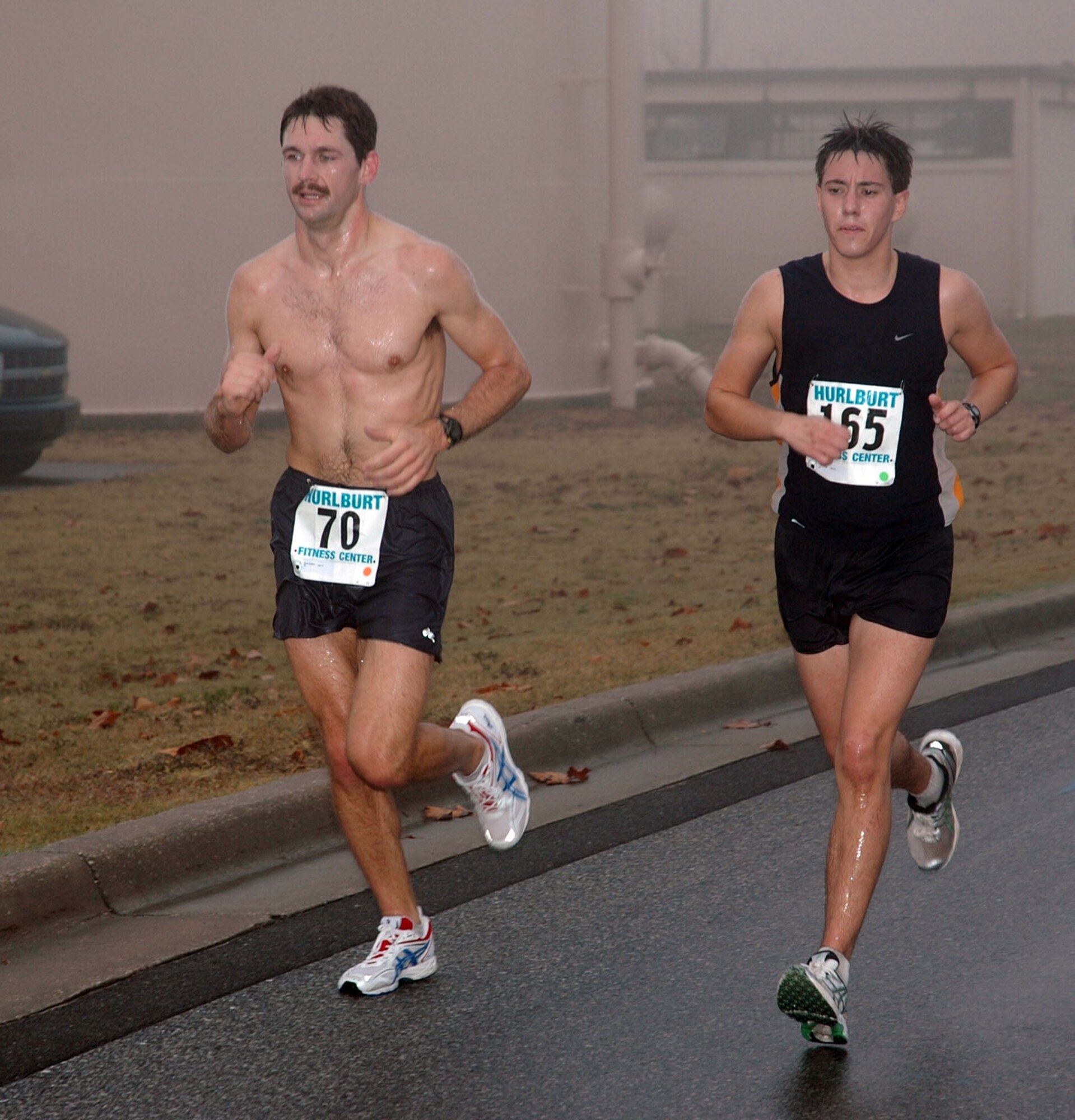 Scott Griffith (left), a captain from Eglin Air Force Base, Fla., and Tim Kogge, a lieutenant assigned to the 6th Special Operations Squadron, ran side-by-side through 12 miles at the Hurlburt Field Heritage Half Marathon Dec. 8.  Griffith outsprinted Kogge to win by 10 seconds, with a time of one hour, 24 minutes and 28 seconds. (U.S. Air Force photo/Master Sgt. Stuart Camp)