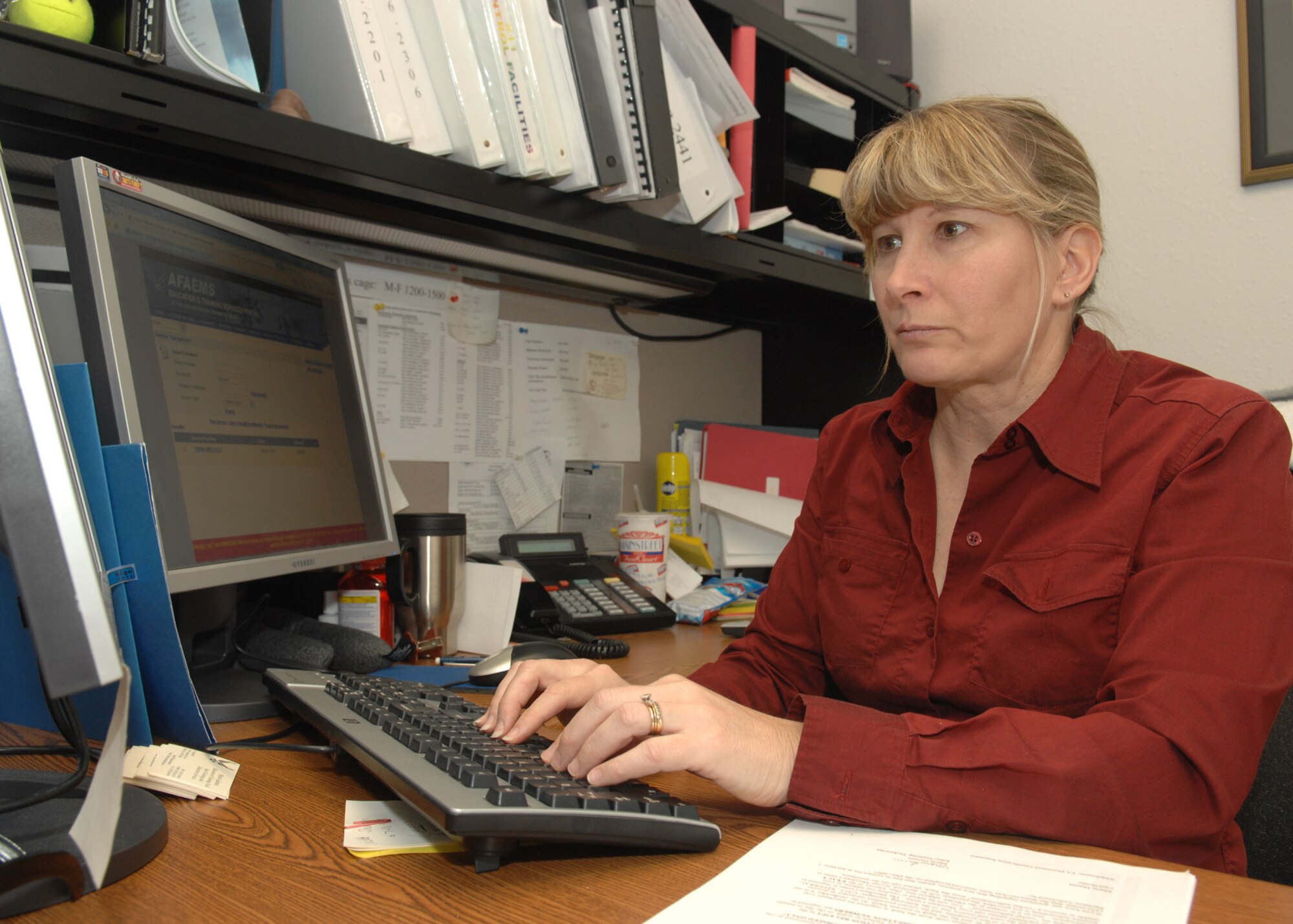 Marie Guinee, 355 Mission Support Squadron, helps the Airman to ensure that they are taken care of with any questions that they might have on education and training here at D-M on Dec.11. Mrs. Guinee won the 2007 Air Force Level Education and Training Specialist, Flight Individual Award category IV.  Mrs. Guinee feels honored to be selected by the Air Force.  She says, “It’s a team effort in our office. Everyone pitches in and I feel that we all won the award.”  (U.S. Air Force photo by SrA Jacqueline Hawkins) (RELEASED)