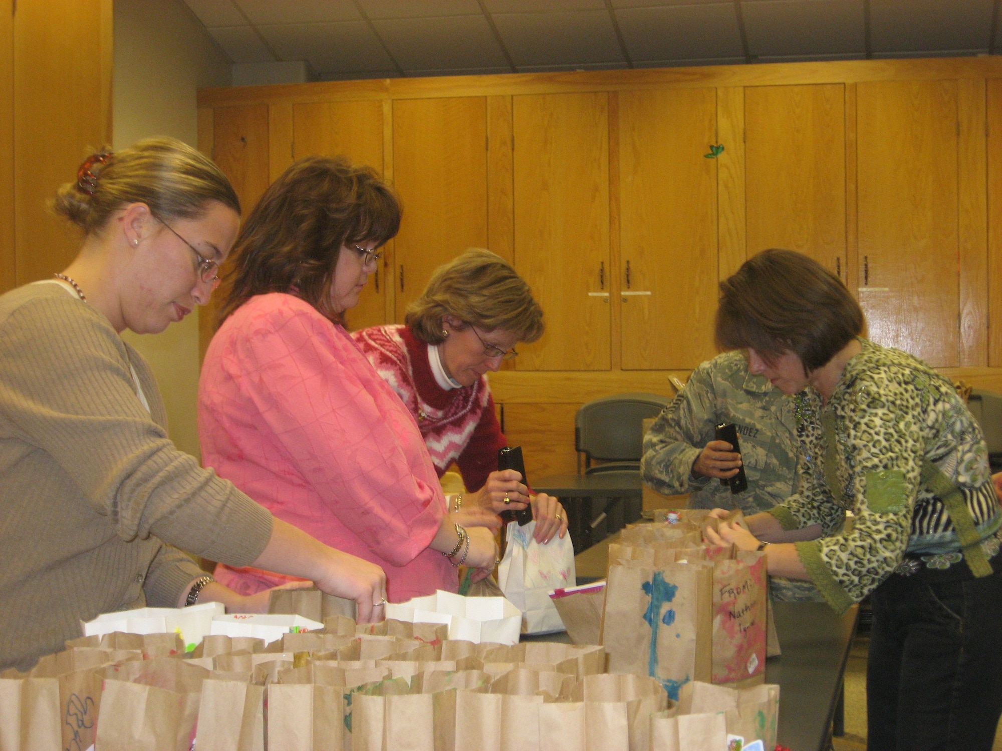 Spouses from the Peterson Spouses Club donate their time Dec. 4 by bagging cookies to be given to single servicemembers living in the base dormitories. The drive, now in its eighth year, gives Airmen, Soldiers, Sailors and Marines a taste of home while they're away from families during the holiday season. (Courtesy photo)