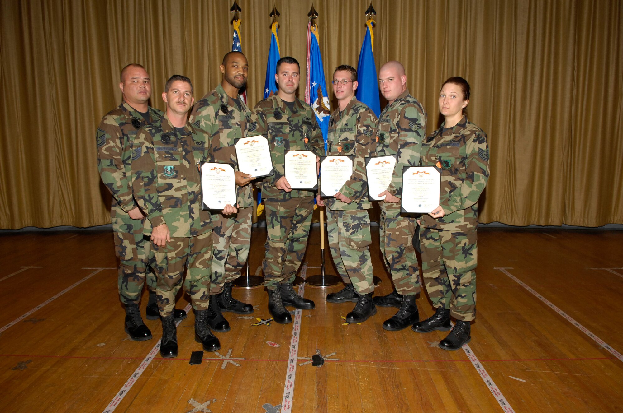 EGLIN AIR FORCE BASE, Fla.--(L-R) Master Sgt. Gregory Pocaigue, Tech Sgt. Jordan Velissariou, Senior Airman Tarrick Jackson, Tech Sgt. Travis Laws, Senior Airman Jacob Sutton, Senior Airman Joseph Fougerousse, and Tech Sgt. Lorri Mayes were presented with Combat Action Medals Dec. 10. Maj. Gen. David Eidsaune, Program Executive Officer for Weapons and Air Armament Center commander, presented the medals at his commander's call. (USAF photo by David Kidd)