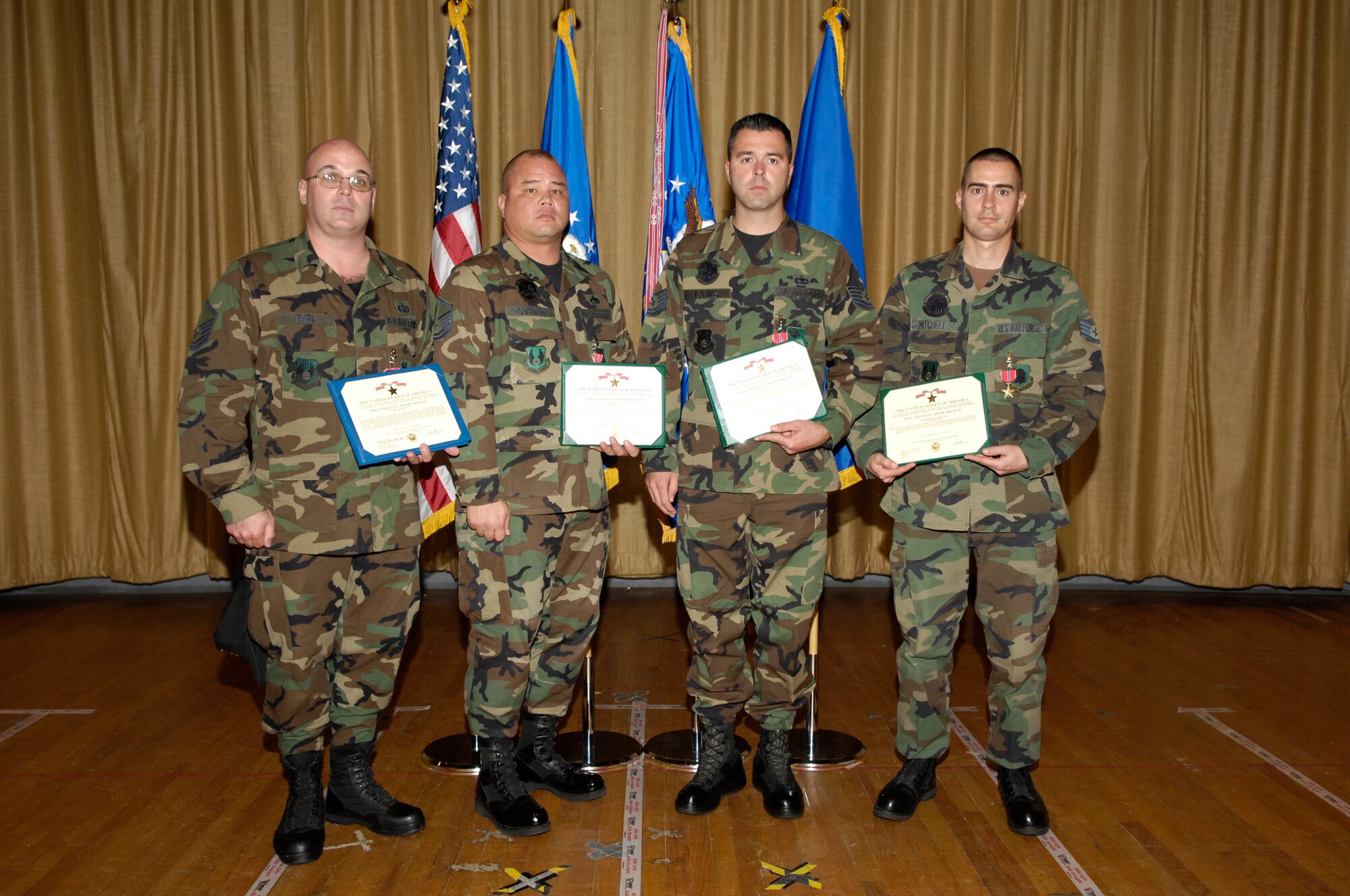EGLIN AIR FORCE BASE, Fla.--(L-r) Master Sgt. Michael Carl, Master Sgt. Gregory Pocaigue, Tech Sgt. Travis Laws, and Staff Sgt. Brad Mitchell were presented with Bronze Stars Dec. 10. Maj. Gen. David Eidsaune, Program Executive Officer for Weapons and Air Armament Center commander, presented the medals at his commander's call. (USAF photo by David Kidd)