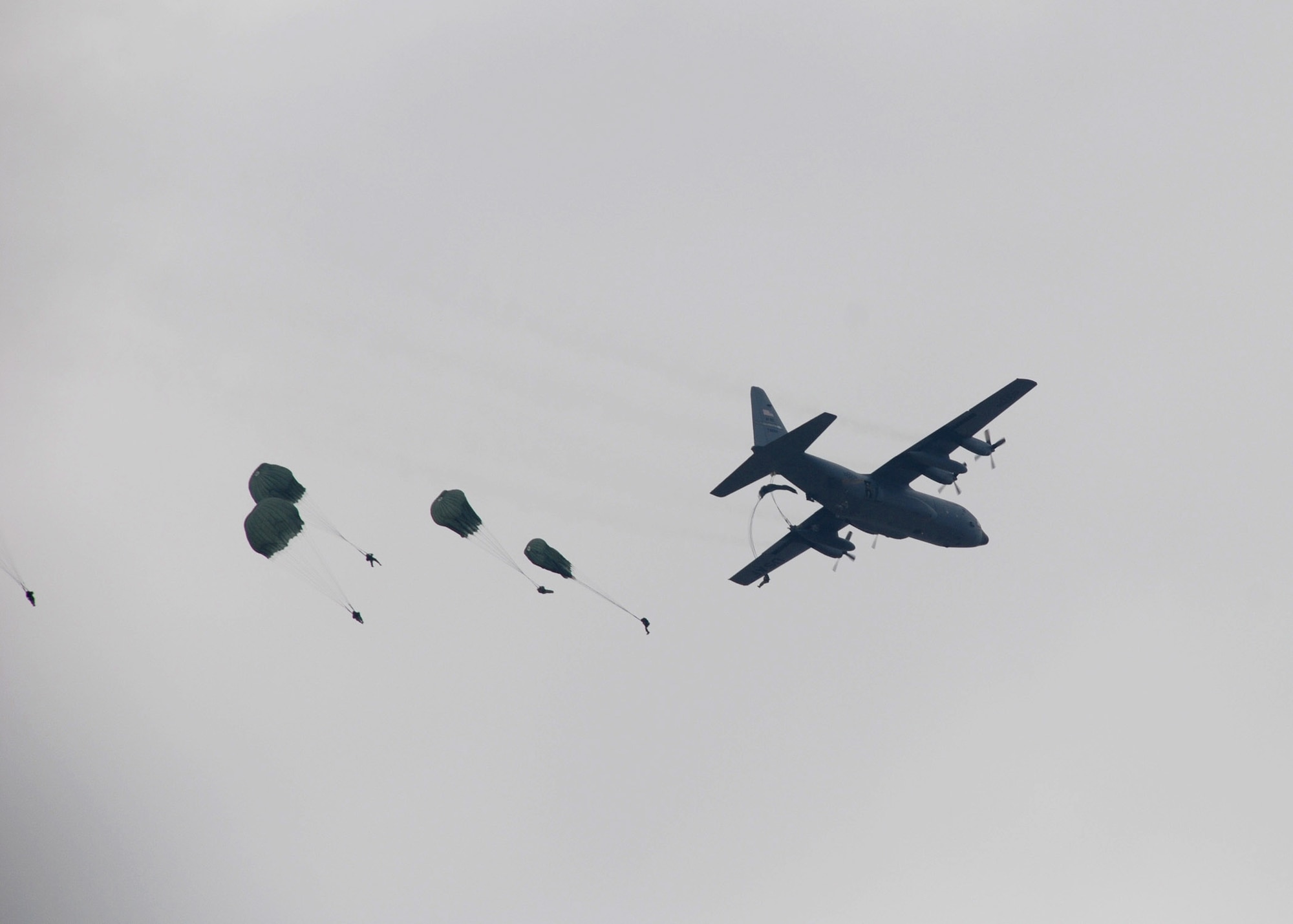 An Air Force Reserve Command C-130 Hercules flown by members of the 95th Airlift Squadron, from Pope Air Force Base, N.C., drops paratroopers during Operation Toy Drop Dec. 8 at the Sicily Drop Zone at Fort Bragg, N.C. More than 1,050 paratroopers jumped during the exercise. (U.S. Air Force photo/Lt. Col. Ann Peru Knabe)