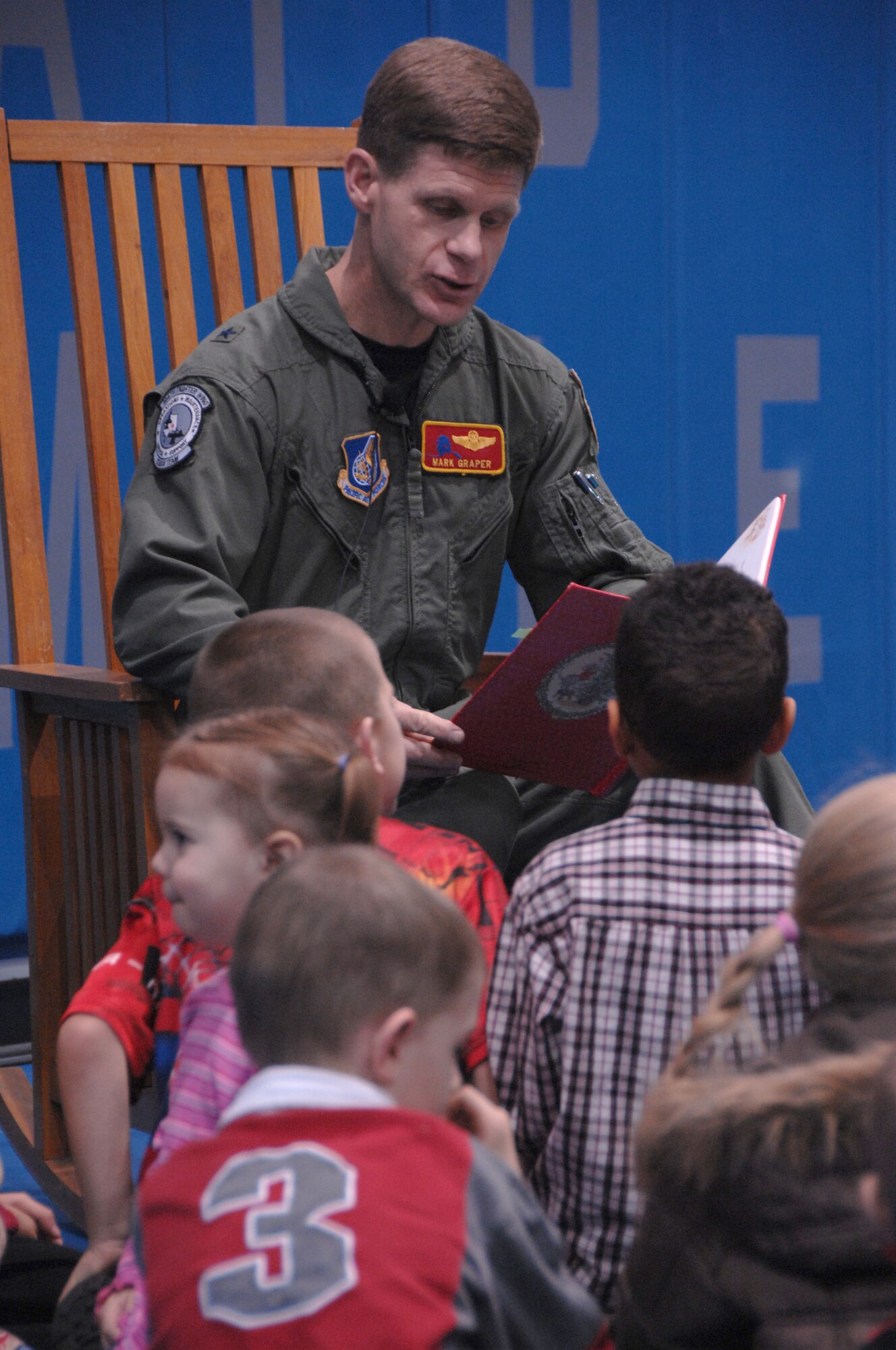 EIELSON AIR FORCE BASE, Alaska --  Brig. Gen. Mark Graper, 354th Fighter Wing commander, reads a Christmas
story to the children of military members of Eielson Dec. 7, 2007. Every year Eielson's commander reads a Christmas story to children of Airmen, followed by a tree lighting  ceremony. (U.S. Air Force photo by Airman 1st Class Christopher Griffin)