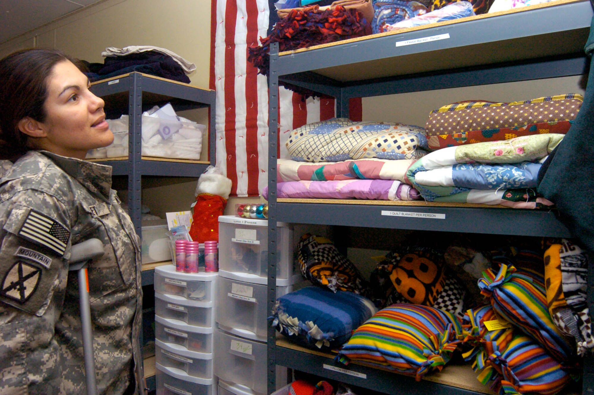 Army Specialist Marcela Supnet decides which quilt to select at the Wounded Warrior Ministry Center at Landstuhl Regional Medical Center, Germany. The handmade quilts and other items are dispensed to wounded warriors and other patients at the hospital. (U.S. Army photo/Thomas Warner)