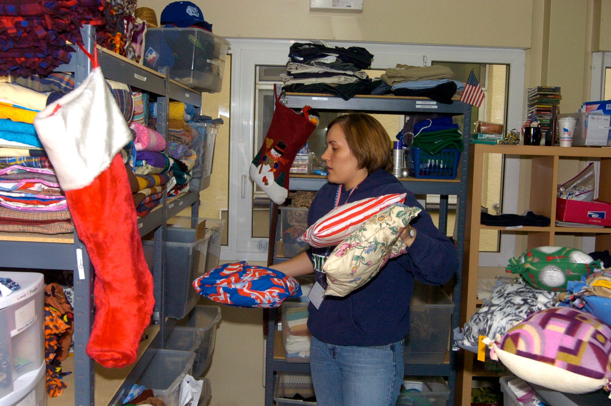 Jenny Clayton stocks shelves at the Wounded Warrior Ministry Center at Landstuhl Regional Medical Center, Germany, which is benefiting from a holiday increase in donations to servicemembers wounded downrange. Ms. Clayton is one 22 volunteers who donate more than 600 hours a month at the center. (U.S. Army photo/Chuck Roberts) 