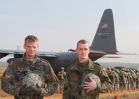Sicily Drop Zone at Fort Bragg, N.C. -- Sergeants Tom Fahrenholz and Christian Rhode, both German jumpmasters pause for a moment as U.S. paratroopers board an Air Force Reserve C-130 during Operation Toy Drop. The exercise included jumpmasters from Canada, Chile and Ireland, and active duty and Reserve paratroopers and Airmen from the U.S. The 440th Airlift Wing, Air Force Reserve, supported the combined joint exercise with C-130 airlift. More than 1,050 paratroopers jumped during the exercise.  (U.S. Air Force photo/Senior Airman Susan Parent)