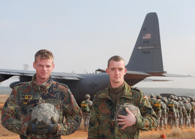 Sicily Drop Zone at Fort Bragg, N.C. -- Sergeants Tom Fahrenholz and Christian Rhode, both German jumpmasters pause for a moment as U.S. paratroopers board an Air Force Reserve C-130 during Operation Toy Drop. The exercise included jumpmasters from Canada, Chile and Ireland, and active duty and Reserve paratroopers and Airmen from the U.S. The 440th Airlift Wing, Air Force Reserve, supported the combined joint exercise with C-130 airlift. More than 1,050 paratroopers jumped during the exercise.  (U.S. Air Force photo/Senior Airman Susan Parent)