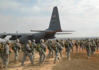 Fifty paratroopers walk to a C-130 with engines running during Operation Toy Drop. The 440th Airlift Wing, Air Force Reserve, supported the combined joint exercise with C-130 airlift. More than 1,050 paratroopers jumped during the exercise held at the Sicily Drop Zone at Fort Bragg, N.C. (U.S. Air Force photo/Lt. Col. Ann Peru Knabe)