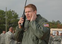 Capt. Adam Shockley, a navigator with the 43rd Airlift Wing, calls from the ground during Operation Toy Drop. The 440th Airlift Wing, Air Force Reserve, supported the combined joint exercise with C-130 airlift. More than 1,050 paratroopers jumped during the exercise held at the Sicily Drop Zone at Fort Bragg, N.C. (U.S. Air Force photo/Lt. Col. Ann Peru Knabe)