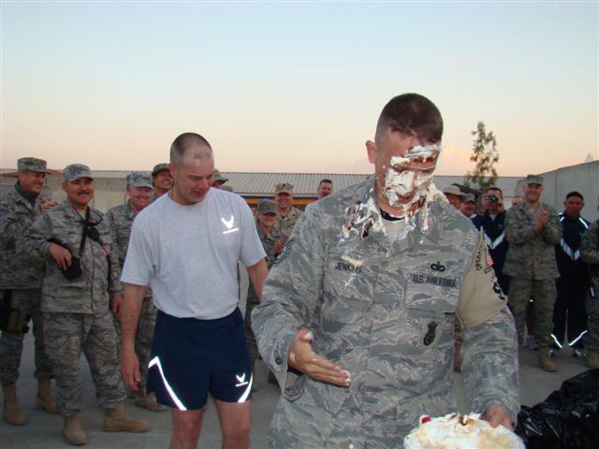 KIRKUK AIR BASE, Iraq -- Tech. Sgt. Joseph Jenkins (front) walks away with a little pie in eye after offering his face up for charity. Sgt. Jenkins is deployed as part of the 916th Security Forces Squadron in Kirkuk and was helping raise money for on-base organizations such as the Top 3 and First Four.