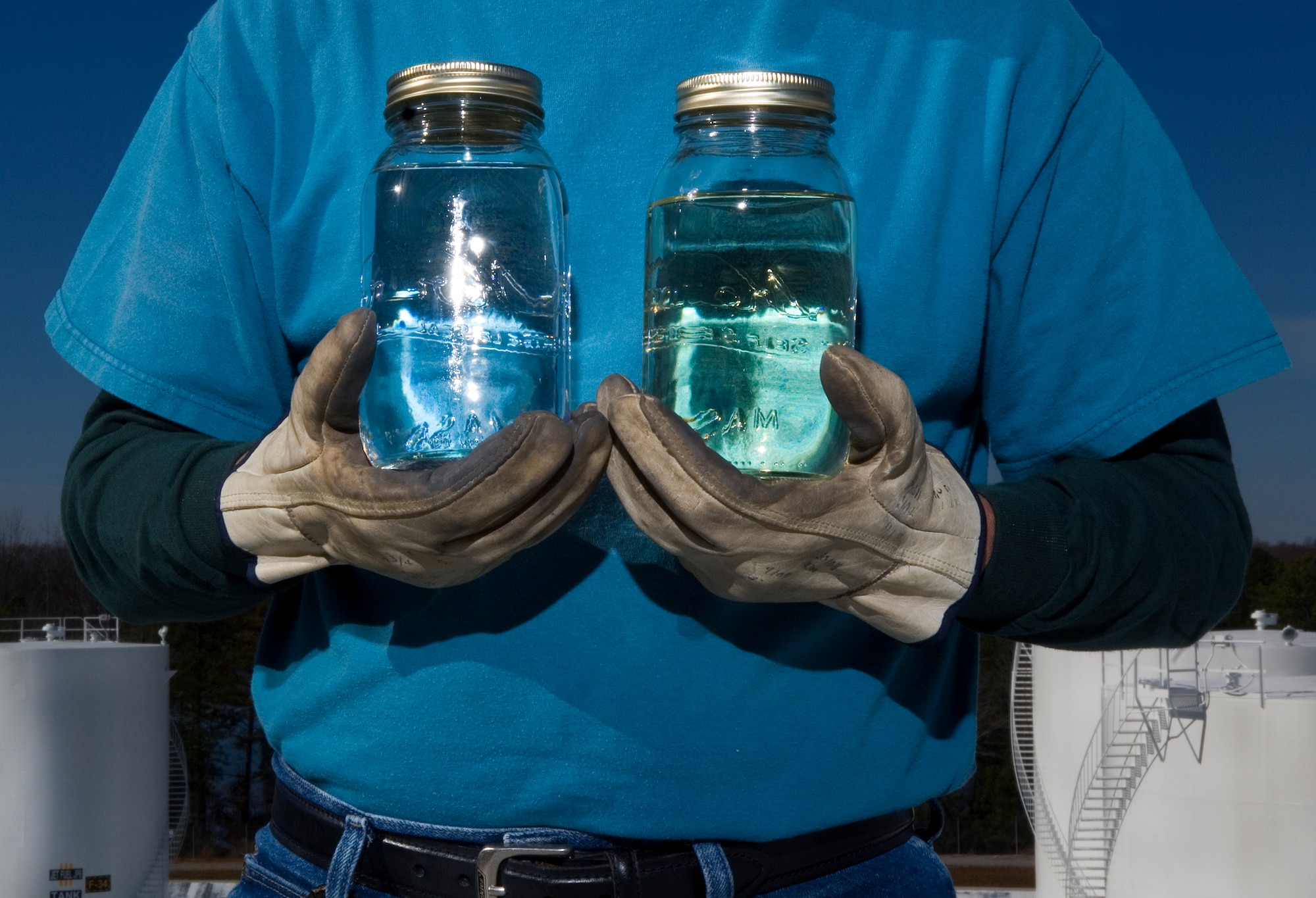 Retired Master Sgt. James Lucas compares jars of Fischer-Tropsch produced synthetic fuel (left) and JP-8 jet fuel Dec. 4 at Arnold Air Force Base, Tenn., The Air Force is testing an alternative fuel source using a 50/50 mix of the two fuels to help reduce U.S. dependancy on foreign oil. Mr. Lucas is a contracted outside machinist for the Arnold Engineering Development Center. (U.S. Air Force photo/Staff Sgt. Bennie J. Davis III)