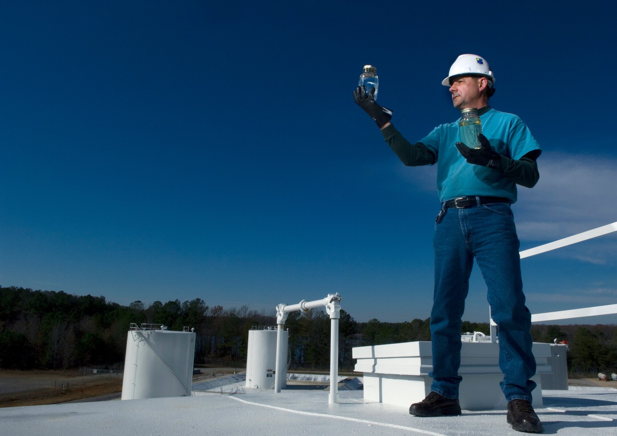 Retired Master Sgt. James Lucas holds up a jar of Fischer-Tropsch produced synthetic fuel, which is mixed with JP-8 jet fuel to produce an alternate fuel source Dec. 4 at Arnold Air Force Base, Tenn. The Air Force is testing the alternative fuel to help reduce U.S. dependancy on foreign oil. Mr. Lucas is a contracted outside machinist for the Arnold Engineering Development Center. (U.S. Air Force photo/Staff Sgt. Bennie J. Davis III)