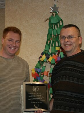 SEYMOUR JOHNSON AIR FORCE BASE, N.C. --  Capt. Ted Janicki (left) stands with his commander, Lt. Col. James Horton during the 916th Communication Squadron's Christmas party held on the December unit training assembly weekend. Capt. Janicki was presented an award for his service to the squadron as he prepares to leave for a new assignment in Virginia.