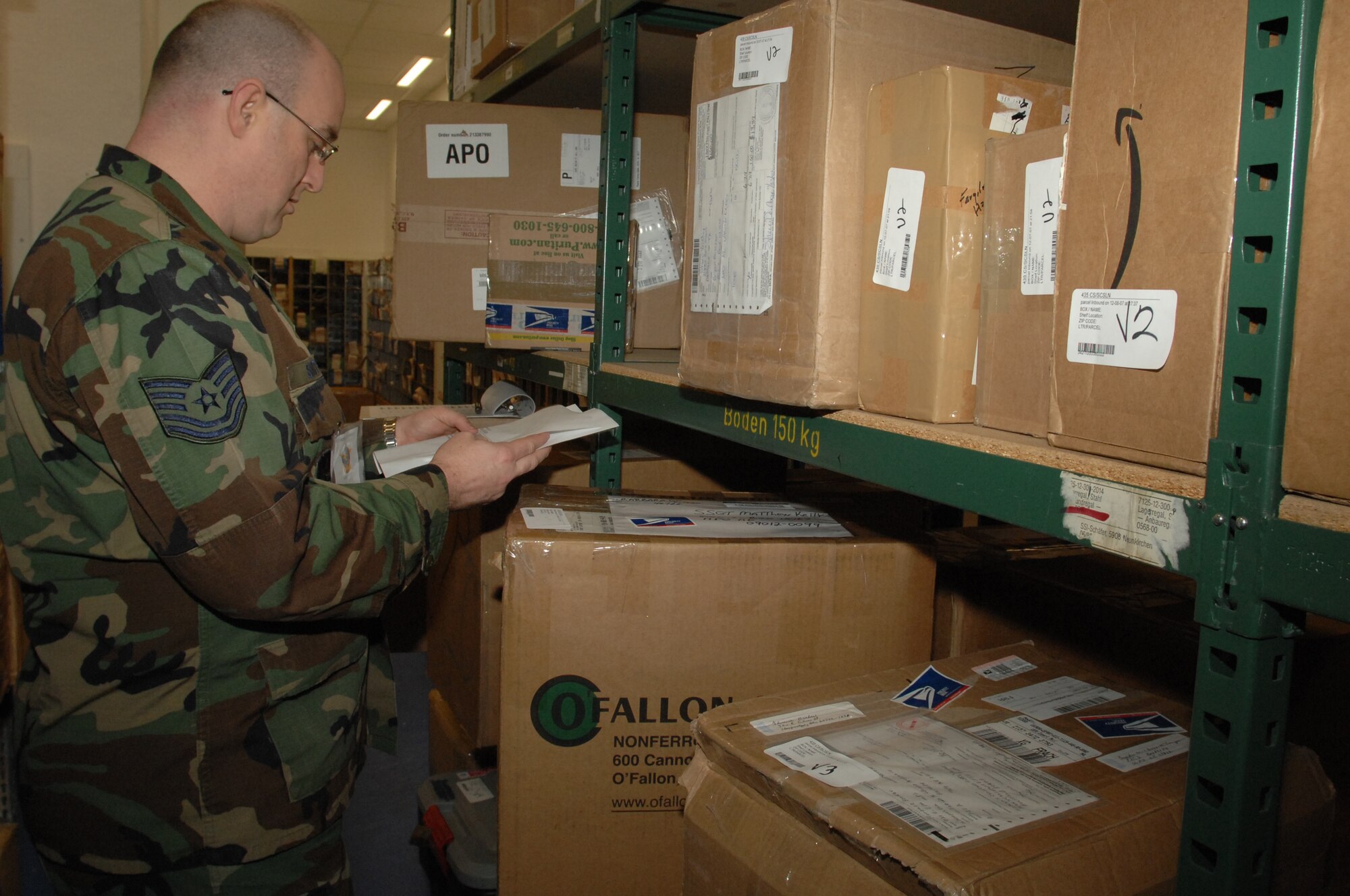 Tech. Sgt. Todd Smith, 435th Communications Squadron, locates a package at the north side post office December 11, 2007 at Ramstein Air Base, Germany.  Many people volunteer to help the post office staff with the overflow of packages during the holiday season. (U.S. Air Force photo/Airman 1st Class Amber Bressler)
