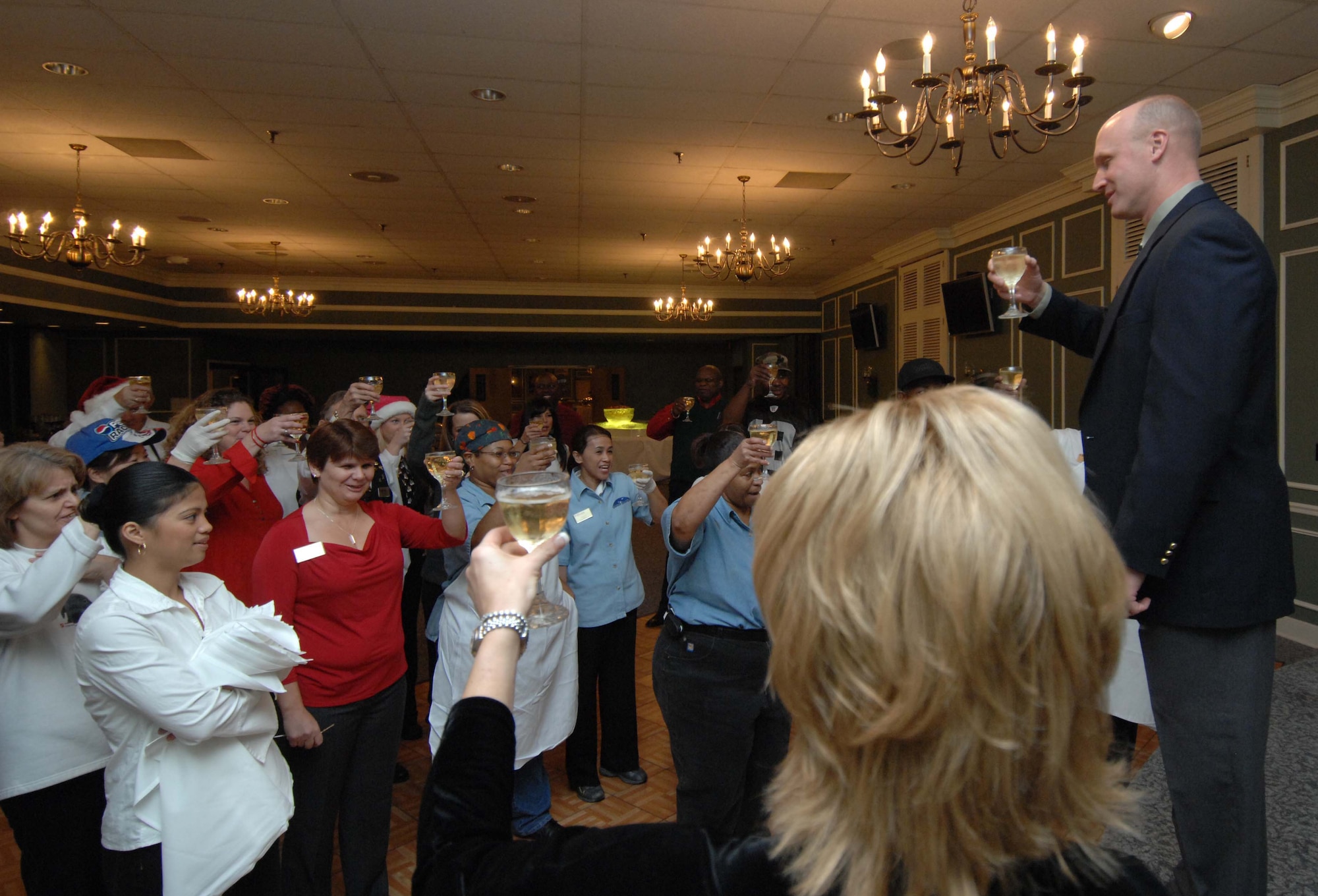 SHAW AIR FORCE BASE, S.C. -- Col. James Post, 20th Fighter Wing commander, raises a glass of champagne with the Carolina Skies Club staff Dec. 8. Colonel Post thanked the staff for their constant improvement and quality of service before the 2007 20th Fighter Wing Holiday Reception. (U.S. Air Force photo/Airman 1st Class Kathrine McDowell)