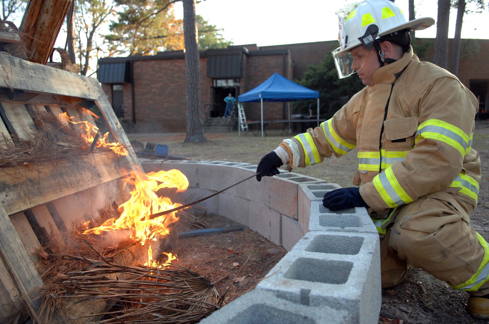 SHAW AIR FORCE BASE, S.C. -- Assistant Fire Chief Blain Schumacher lights the bonfire for the 2007 20th Fighter Wing Holiday Reception Dec. 8. The fire, lit throughout the event, was one of the many highlights for the thousands of Shaw members in attendance. The holiday party new menus of appetizers, hors d'oeuvres and desserts from the Carolina Skies kitchen as well as jazz musicians playing Christmas favorites. (U.S. Air Force photo/Airman 1st Class Kathrine McDowell)