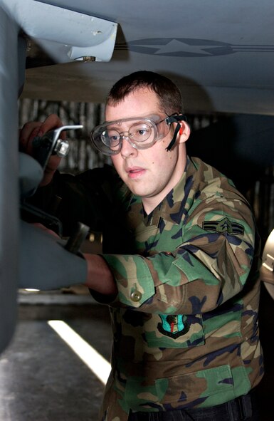 MISAWA AIR BASE, Japan -- Airman 1st Class Robert Wade, 13th Aircraft Maintenance Unit, prepares an F-16 for weapons loading during the annual Load Crew Competition here, Nov 30, 2007. The competion pits two three-person teams against one another with a time limit of 30 minutes. (US Air Force photo by Airman 1st Class Eric Harris)