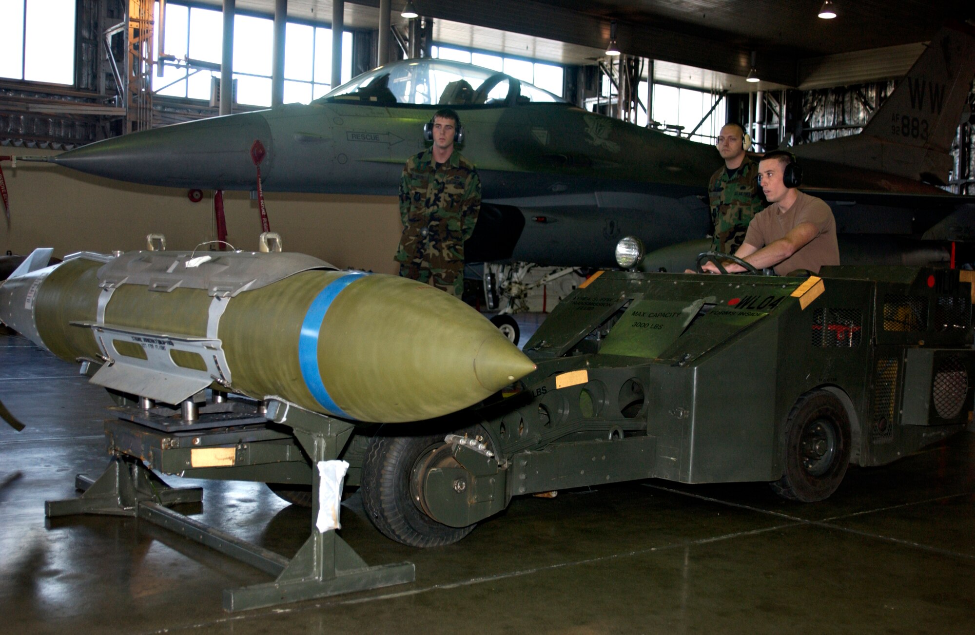 MISAWA AIR BASE, Japan -- Airman 1st Class Jolin Daigneault, 13th Aircraft Maintenance Unit, lifts a GBU-31 bomb to move it into position for loading an F-16 during the annual Load Crew Competition here, Nov 30, 2007. Two teams, both from the 13th AMU, competed and were required to load a GBU-31 bomb as well as an AIM 9 and AIM 120 missile. (US Air Force photo by Airman 1st Class Eric Harris)