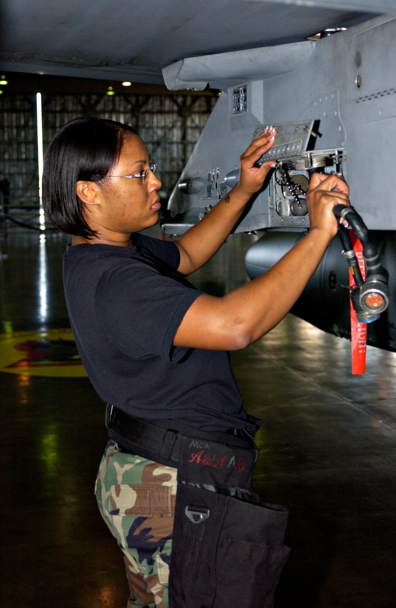 MISAWA AIR BASE, Japan -- Senior Airman Takiyah Prince, 13th Aircraft Maintenance Unit, prepares an F-16 for weapons loading during the annual Load Crew Competition here, Nov 30, 2007. The winning team will be announced at the 35th Maintenance Group awards ceremony early next year. (US Air Force photo by Airman 1st Class Eric Harris)