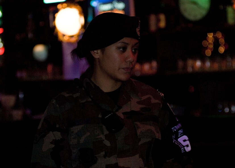 KUNSAN AIR BASE, South Korea—  Airman 1st Class Kassandra Naone, 8th Security Forces town patrolman, stops in a club while doing her rounds here Dec. 8. The mission of town patrol is to provide a safe and secure environment to United States Forces Korea personnel. (U.S. Air Force Photo/Staff Sgt. Araceli Alarcon) 



