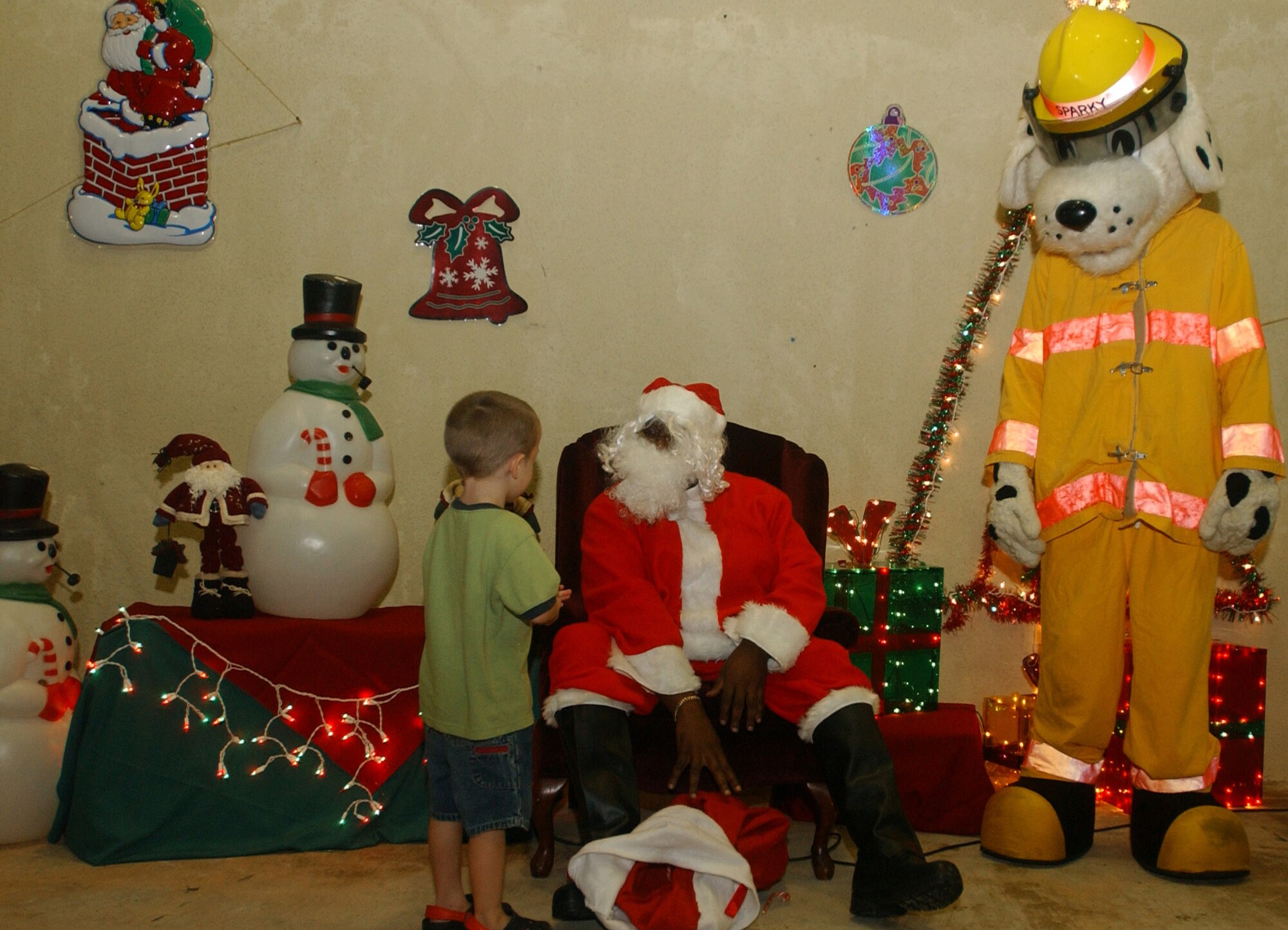 Santa Claus showed up for the celebration during Andersen's Christmas Tree Lighting ceremony Dec. 7, and children got a chance to tell him their Christmas wishes. Sparky the Fire Dog was also on site to remind children about safety during the holiday season. (U.S. Air Force photo/Senior Airman Brian Kimball)