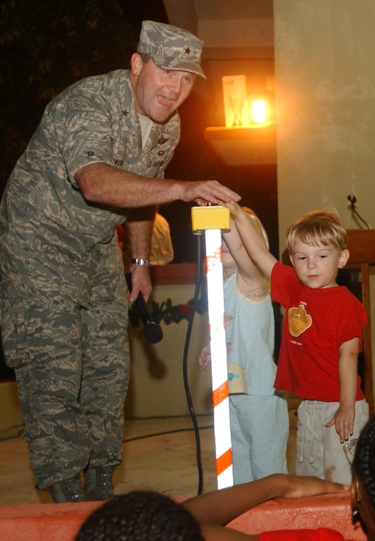 Brig. Gen. Douglas Owens, 36th Wing commander, chose two children from the audience to assist him in officially welcoming in the holiday season with the traditional Christmas Tree Lighting ceremony Dec. 7. (U.S. Air Force photo/Senior Airman Brian Kimball)
