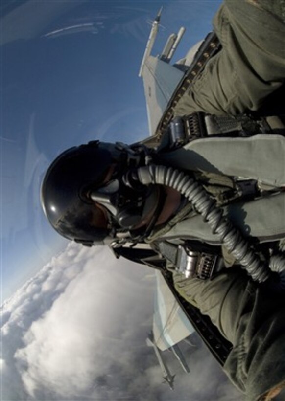 U.S. Air Force Master Sgt. Jack Braden turns sideways in this self-portrait while riding in an F-16 Fighting Falcon aircraft over a training range in South Korea during a close-air-support training mission Nov. 29, 2007.  Pilots use the simulated training missions to keep their war-fighting skills honed.  Braden, from the 8th Fighter Wing's public affairs office, was photographing other aircraft on the training mission.  