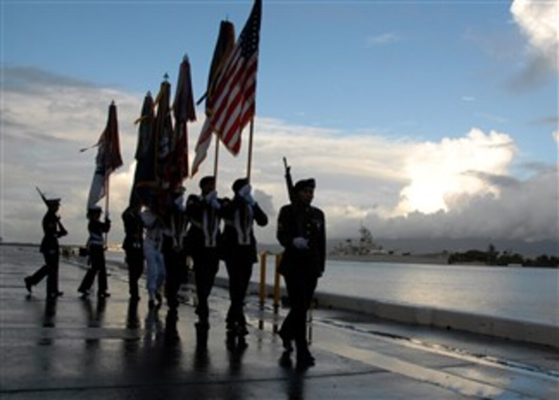 A joint service color guard parades during a dedication ceremony for the USS Oklahoma Memorial on Ford Island, Hawaii, Dec. 7, 2007. The memorial honors the 429 sailors and Marines who lost their lives after the ship was hit by five torpedoes and capsized at Pearl Harbor Dec. 7, 1941. 