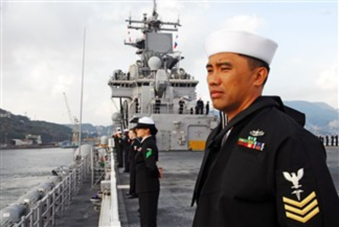 U.S. Navy Petty Officer 1st Class Wyeth S. Daniel and sailors assigned to amphibious assault ship USS Essex man the rails after a successful completion of Fall Patrol 2007, Dec. 11, 2007. 