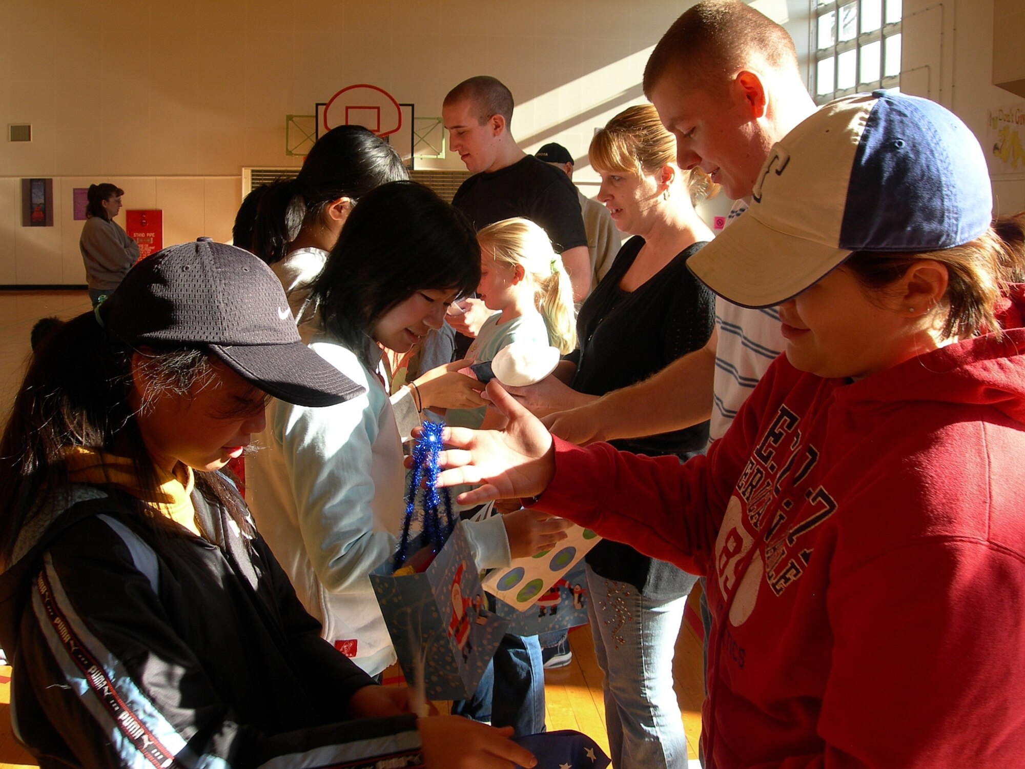 MISAWA AIR BASE, Japan -- Japanese school children present volunteers with gifts for all their work in putting together a Christmas cultural exchange between the Japanese students and American students here Dec. 8, 2007. (Photo by Simon Bernard)
