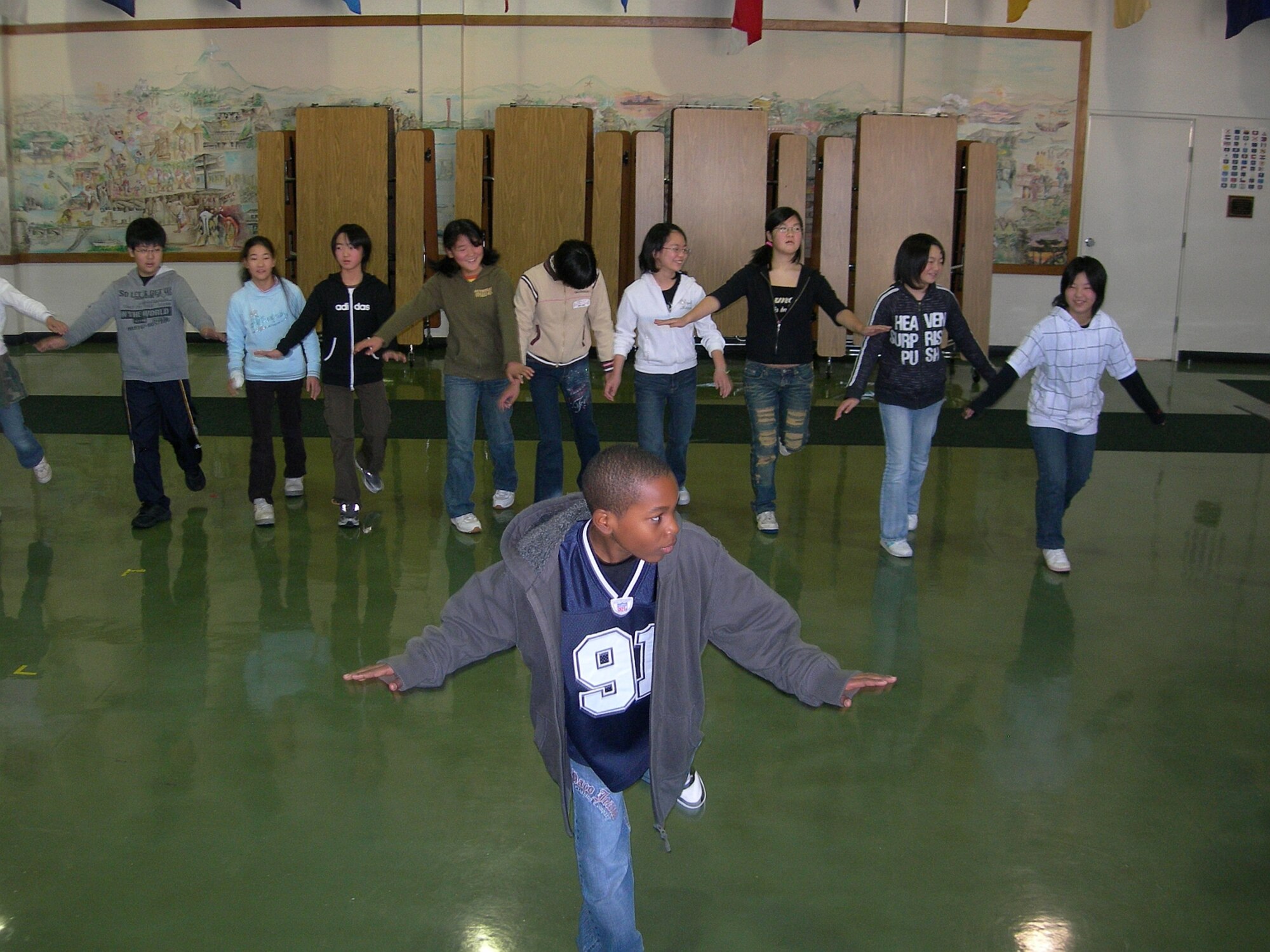MISAWA AIR BASE, Japan -- Sixth grader Terrell Boley, from Sollars, teaches hip-hop moves to an enthusiastic group of children. The Japanese children came from the five different elementary schools in Oirase Town to join in a Christmas cultural exchange here Dec. 8, 2007. (Photo by Simon Bernard)
