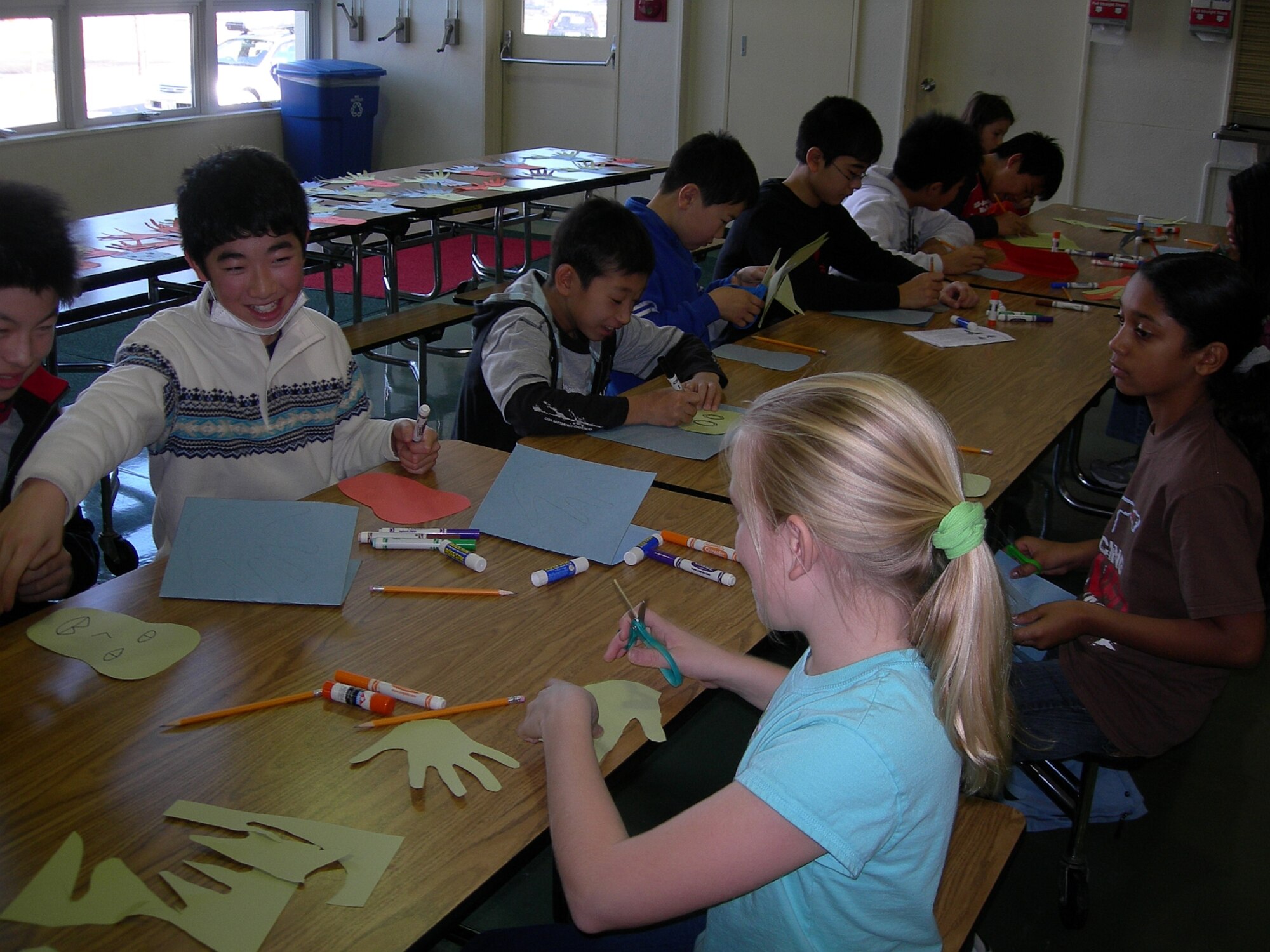 MISAWA AIR BASE, Japan -- Haruya Sasaki, a student at Tagadai Elementary School, and Alexis Beshears, a student at Sollars, share smiles and tips on the best way to make the reindeer decoration at the arts and crafts corner during a Christmas cultural exchange here Dec. 8, 2007. (Photo by Simon Bernard)

