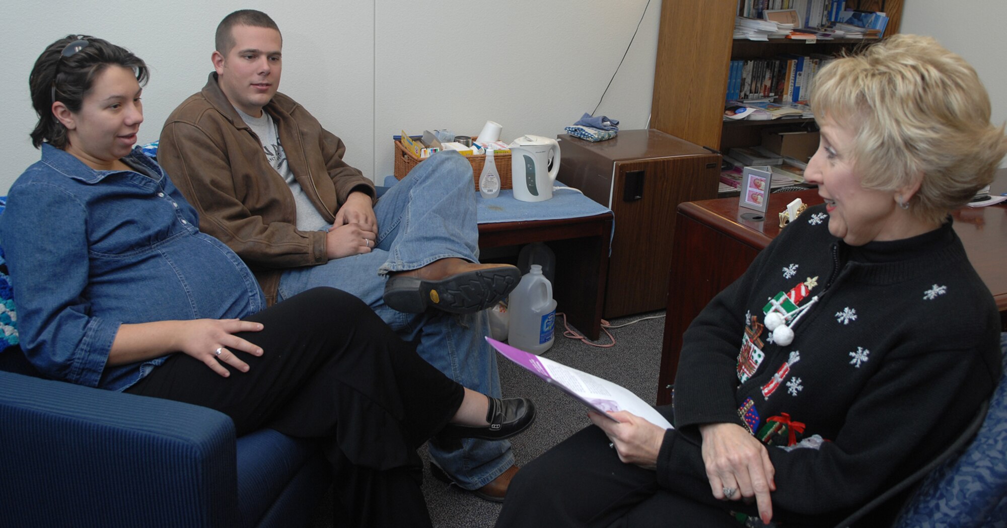 Airman 1st Class Zach Garretson, a 57th Aircraft Maintenance Squadron crew chief, and his wife, Karen, discuss pregnancy topics with their nurse, Mrs. Ellie Hauck of the 99th Medical Operations Squadron, as part of the New Parent Support Program, Dec. 12. Family Advocacy sponsors the program for first-time parents as means to promote positive parenting skills to Nellis Airmen. (U.S. Air Force photo by Staff Sgt. Scottie T. McCord)