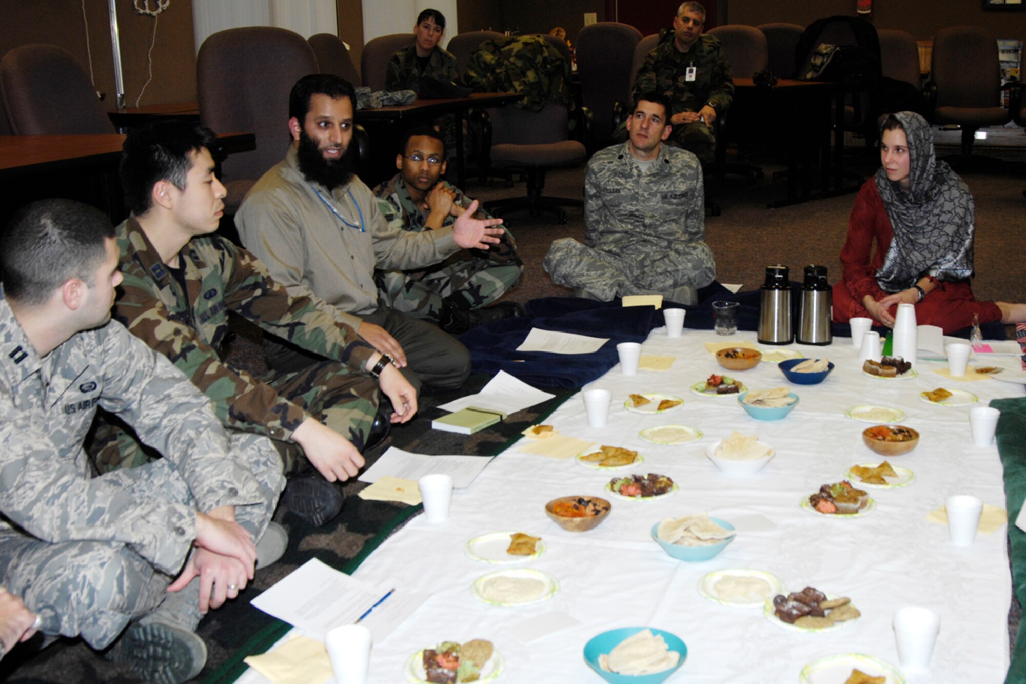 HANSCOM AFB, Mass. -- Mohammad Yaqub, 850th Electronic Systems Group, (third from left) shares information about Middle Eastern cultures during the Airman and Family Readiness Center-sponsored Culture Clash class Dec. 11. In addition to learning facts about Middle Eastern cultures, class attendees, some of whom will deploy soon, ate a Middle Eastern-style meal and were provided with country-specific handbooks and booklets with tips on interacting with people from different countries. Class facilitator 2nd Lt. Felisa Dyrud, 66th Mission Support Squadron, wore a hijab to the class to give class attendees a feel for the type of garb that is worn in some Middle Eastern countries. The lieutenant lived in Afghanistan for nine months before entering the Air Force. (U.S. Air Force photo by Linda LaBonte Britt)