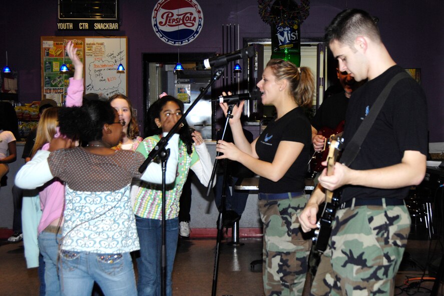 HANSCOM AFB, Mass. -- Base youth jam to the music of the Air Force Band of Liberty's rock ensemble, Afterburner, during an afternoon concert at the Youth Center Dec. 11. The event was intended to provide youth with a healthy alternative to having fun without using drugs or alcohol. December is National Drunk and Drugged Driving Awareness Month. (U.S. Air Force photo by Linda LaBonte Britt)