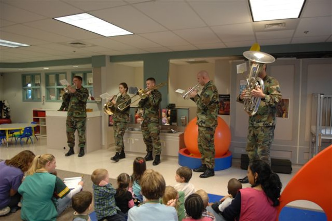 Members of the Offutt Brass share some holiday spirit as they perform for children at Ellsworth Air Force Base.  Offutt Brass is one of seven ensembles from the USAF Heartland of America Band that divided up to visit six Air Force bases in the midwest sharing the holiday spirit with military members and their families.