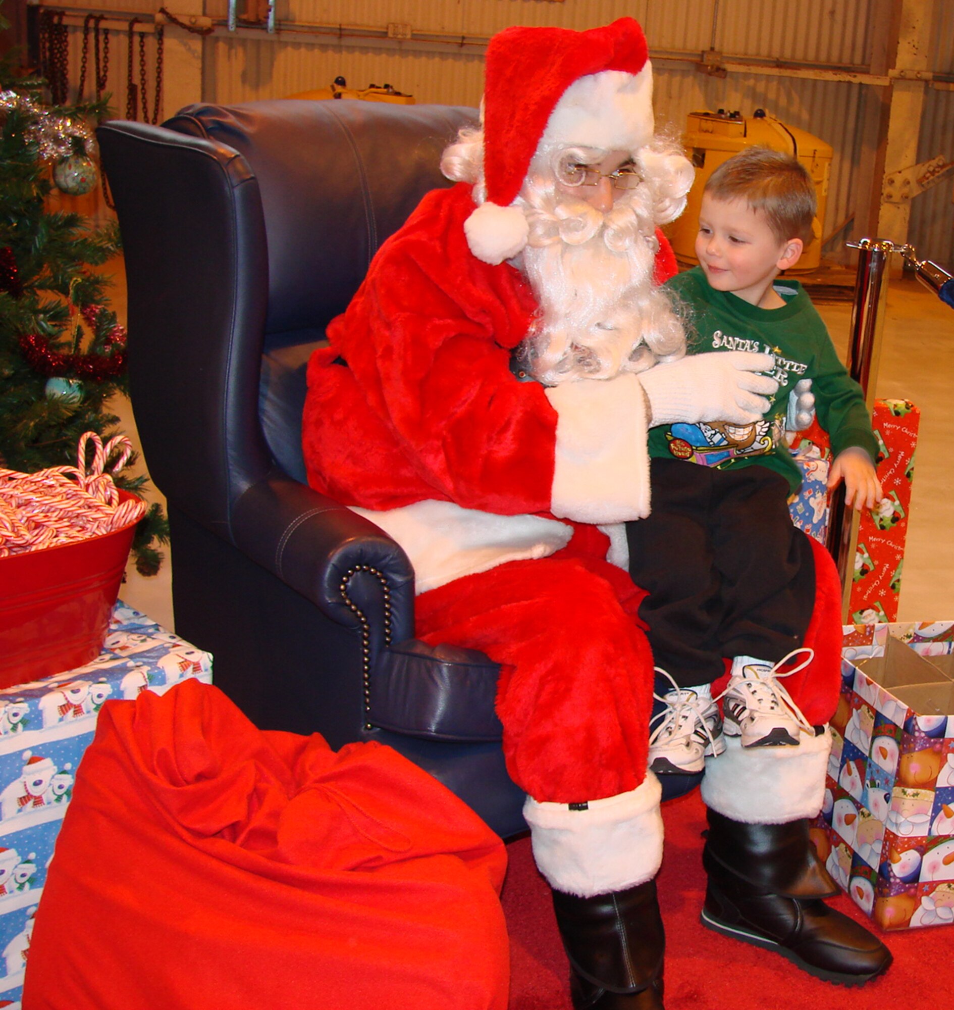 Aidan Gaddis, 3, son of Cliffa and Darryl Gaddis of Systems Research Group, lets Santa know what he wants for Christmas. (U.S. Air Force photo by Tech. Sgt. Mary Davis)