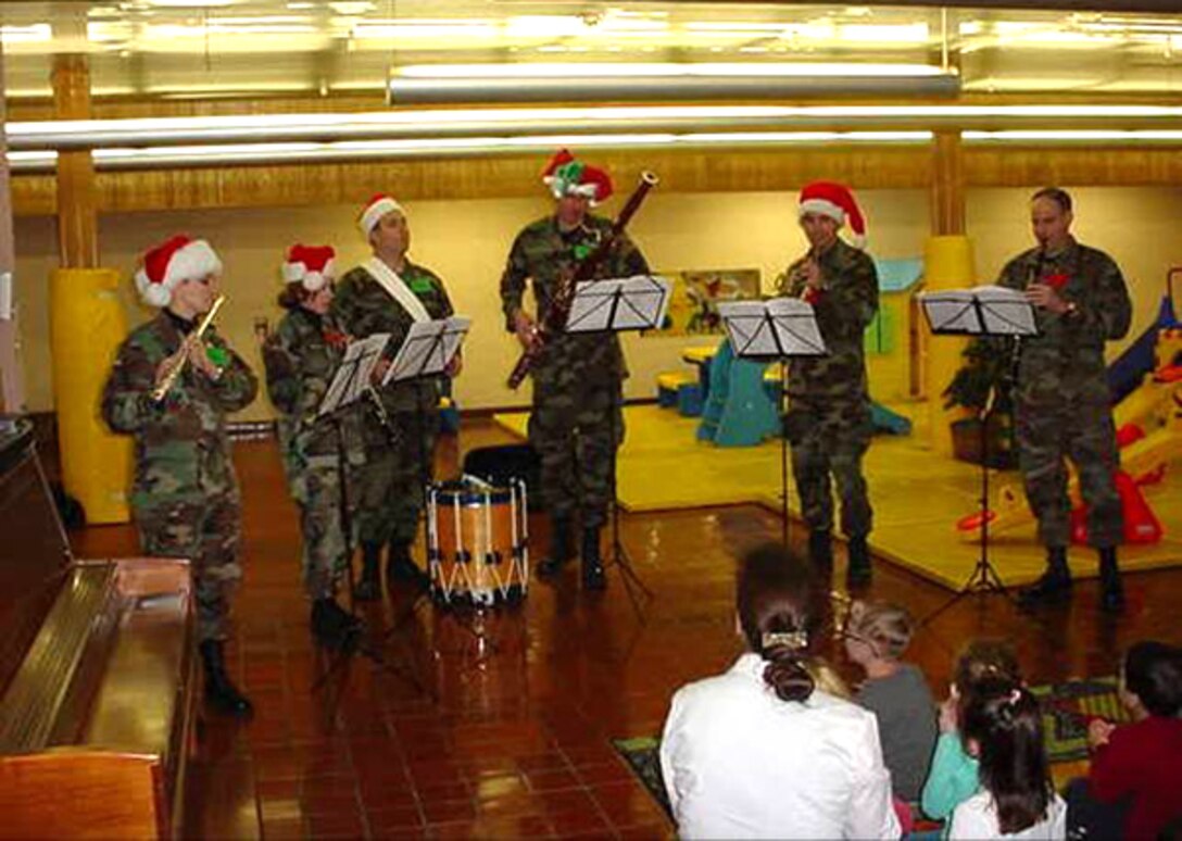 Members of the Winds of Freedom woodwind quintet brought holiday cheer to children at the Enrichment Center Preschool at Offutt AFB.  Winds of Freedom was one of seven ensembles from the USAF Heartland of America Band that divided up to visit six Air Force bases in the midwest sharing the holiday spirit with military members and their families.