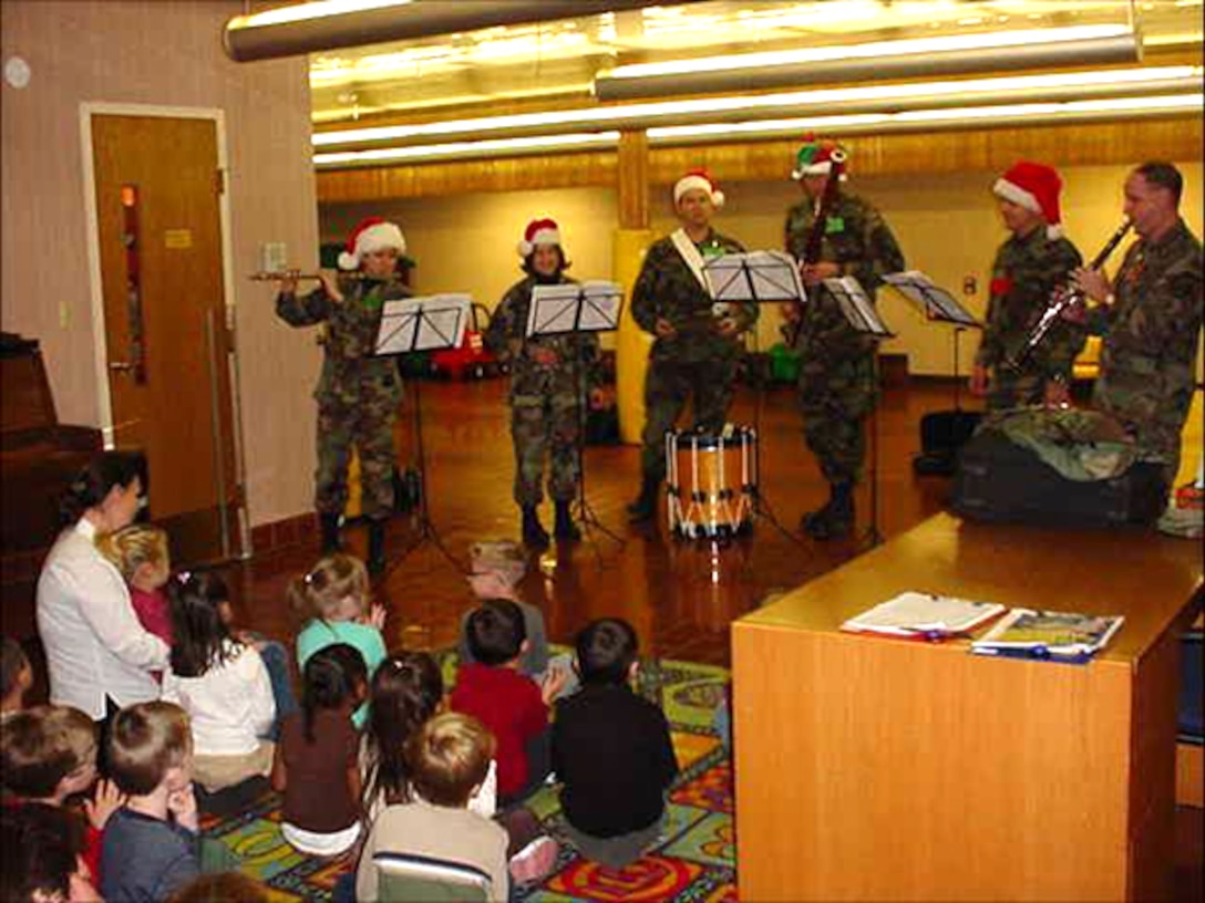 Members of the Winds of Freedom woodwind quintet brought holiday cheer to children at the Enrichment Center Preschool at Offutt AFB.  Winds of Freedom was one of seven ensembles from the USAF Heartland of America Band that divided up to visit six Air Force bases in the midwest sharing the holiday spirit with military members and their families.