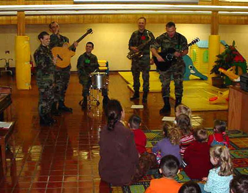 Members of the rock band, Raptor, brought holiday cheer to children at the Enrichment Center Preschool at Offutt AFB.  Raptor was one of seven ensembles from the USAF Heartland of America Band that divided up to visit six Air Force bases in the midwest sharing the holiday spirit with military members and their families.