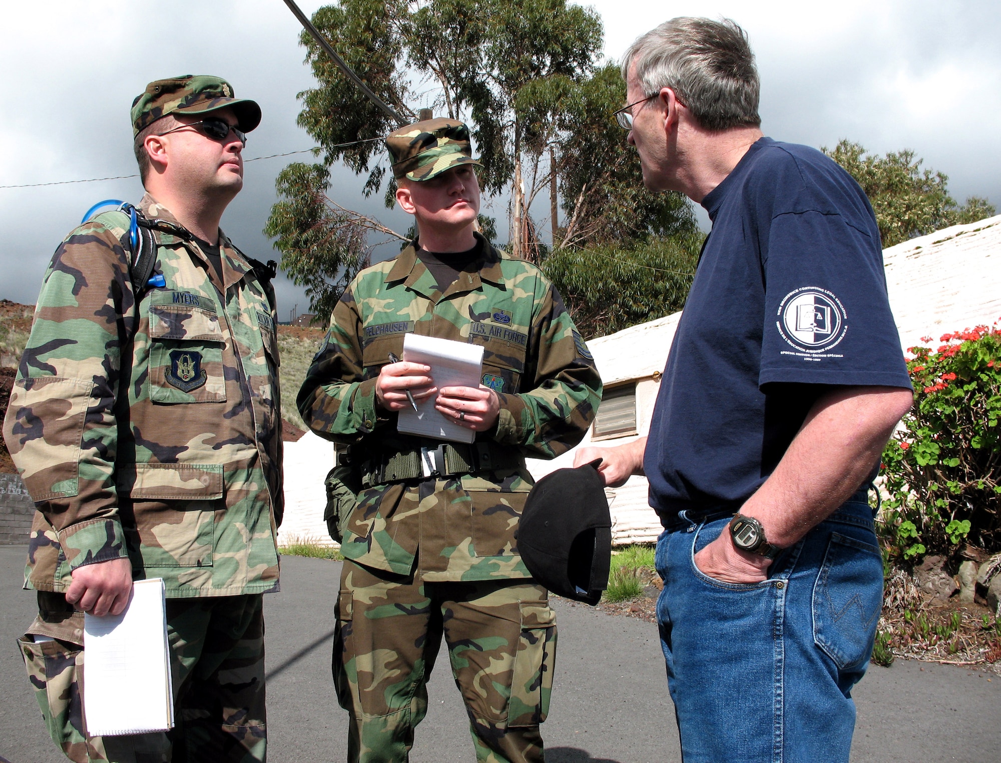 Maj. Peter Meyers, a lawyer, and Tech. Sgt. Lee Feldhausen, a paralegal, both from the Air Force Reserve Command, negotiate a situation Dec. 10 with a simulated non-governmental official, played by Canadian Army Maj. Warren Fensen. They and 21 other military members are deployed to the island of Hawaii's Pohakuloa Training Area for the Pacific Air Forces' PACJOLE, or Pacific Joint Operations Legal Exercise, which runs from Dec. 9 to 14. (U.S. Air Force photo/Tech. Sgt. Chris Vadnais)