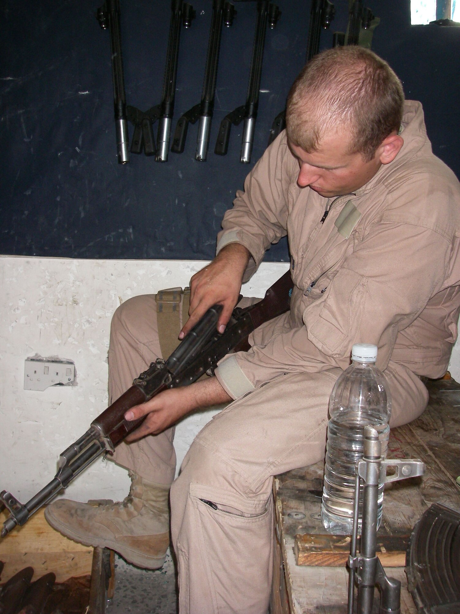 Senior Airman John Soules, 741st Missile Security Forces Squadron member, inspects an AK-47, a gas operated assault rifle created by the Soviet Union, during his daily detail at an Iraqi police station in Baghdad in early June. Airman Soules was presented the Purple Heart and Air Force Combat Action Medal for wounds received in action June 28, 2007. He volunteered for the 365-day deployment to support Operation Iraqi Freedom. (U.S. Air Force photo) 