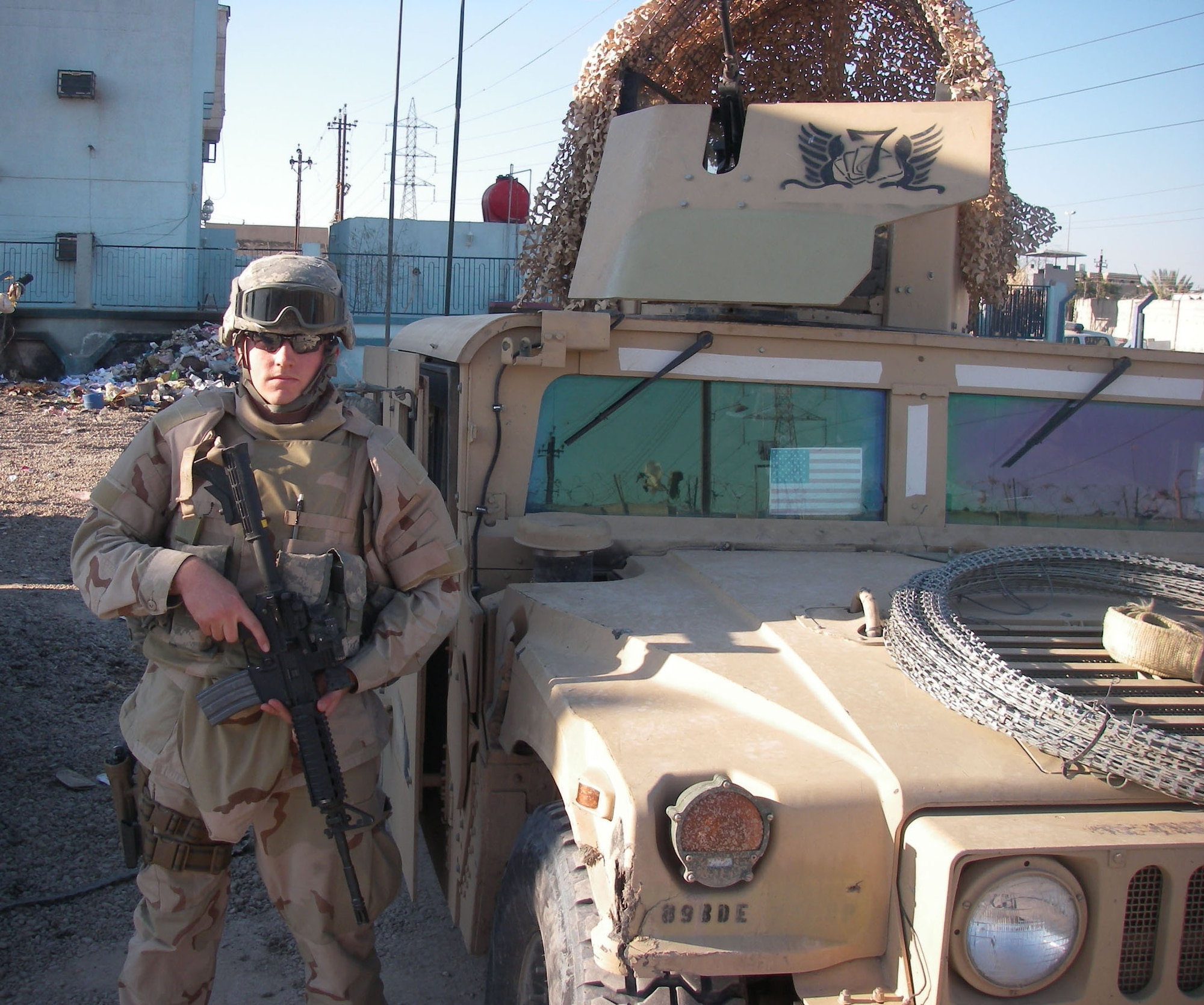 Senior Airman John Soules, 741st Missile Security Forces Squadron member, stands in front of an Iraqi police station in Baghdad in early June. Airman Soules was presented the Purple Heart and Air Force Combat Action Medal for wounds received in action June 28, 2007. He volunteered for the 365-day deployment to support Operation Iraqi Freedom. (U.S. Air Force photo) 