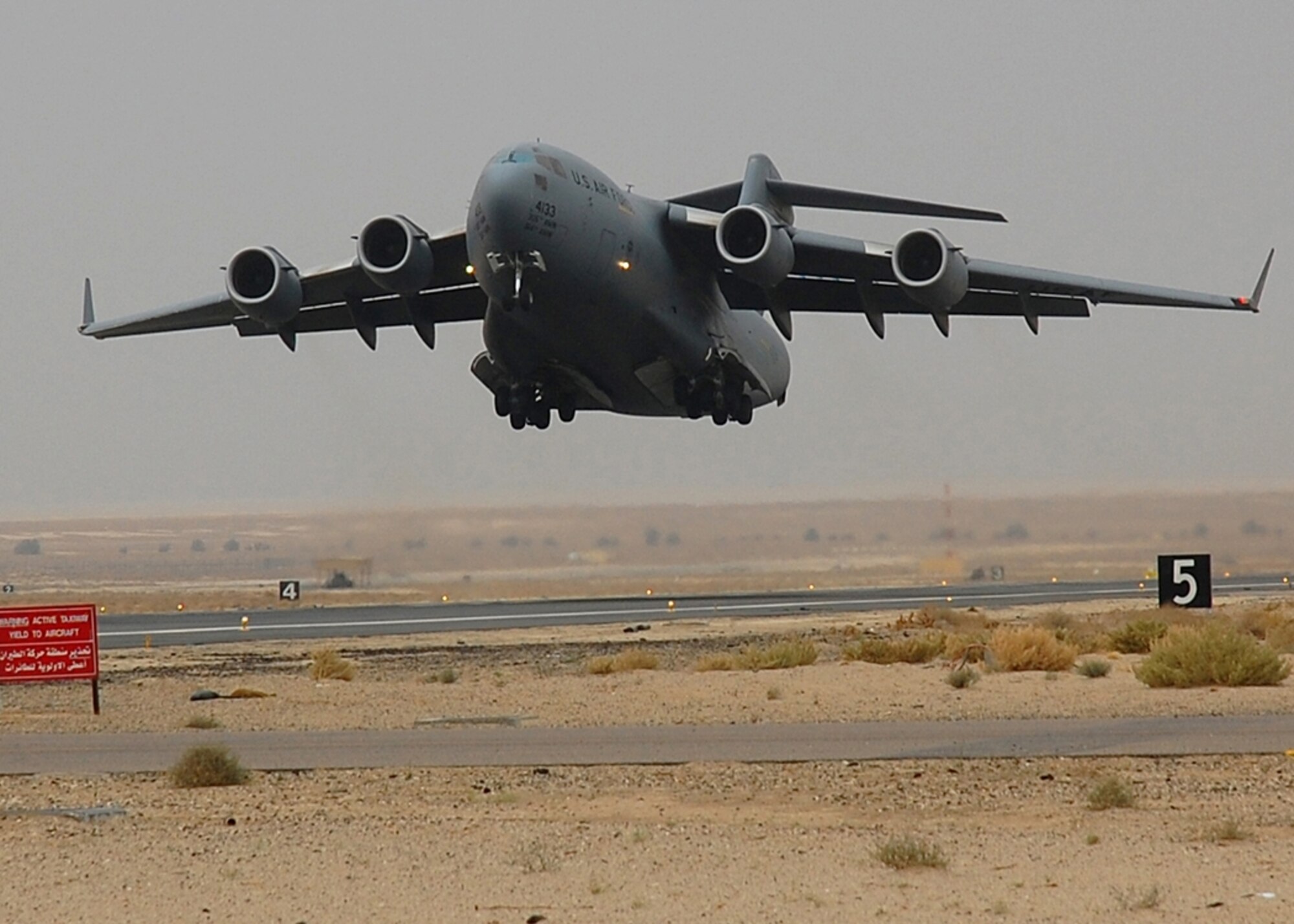 SOUTHWEST ASIA – An Air Force C-17 Globemaster III from McGuire AFB, N.J., takes off from an air base in Southwest Asia.  The C-17's primary mission in the AOR is to transport service members and cargo throughout the Middle East in support of Operations Enduring and Iraqi Freedom.  (U.S Air Force photo by Staff Sgt. Tia Schroeder)