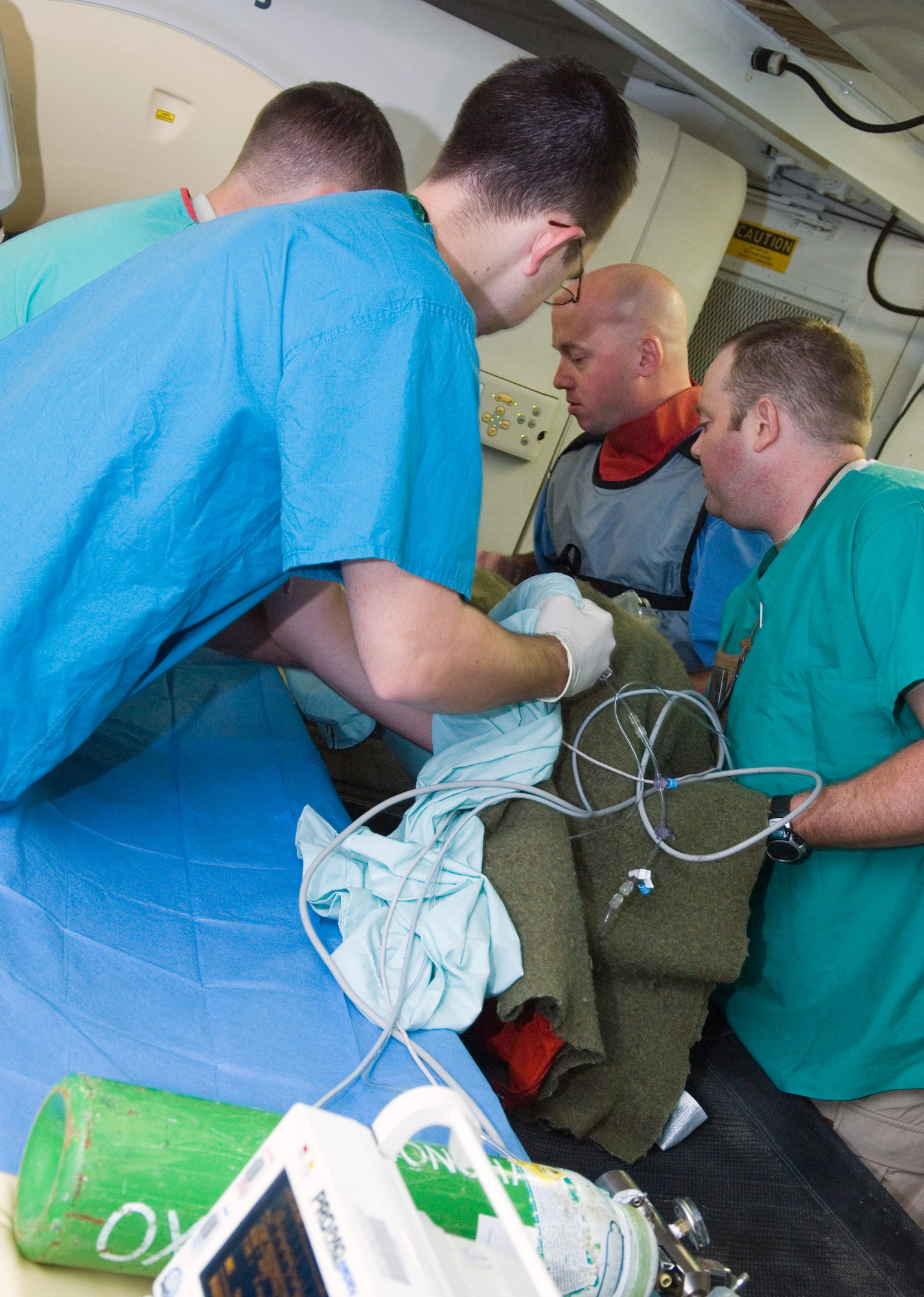 Emergency room and radiology Airmen lift an Iraqi boy from the CT scanner to a litter at the Air Force Theater Hospital at Balad Air Base, Iraq. The boy was scanned to more accurately check for internal bleeding or other bodily trauma. (U.S. Air Force photo/Senior Airman Travis Edwards) 
