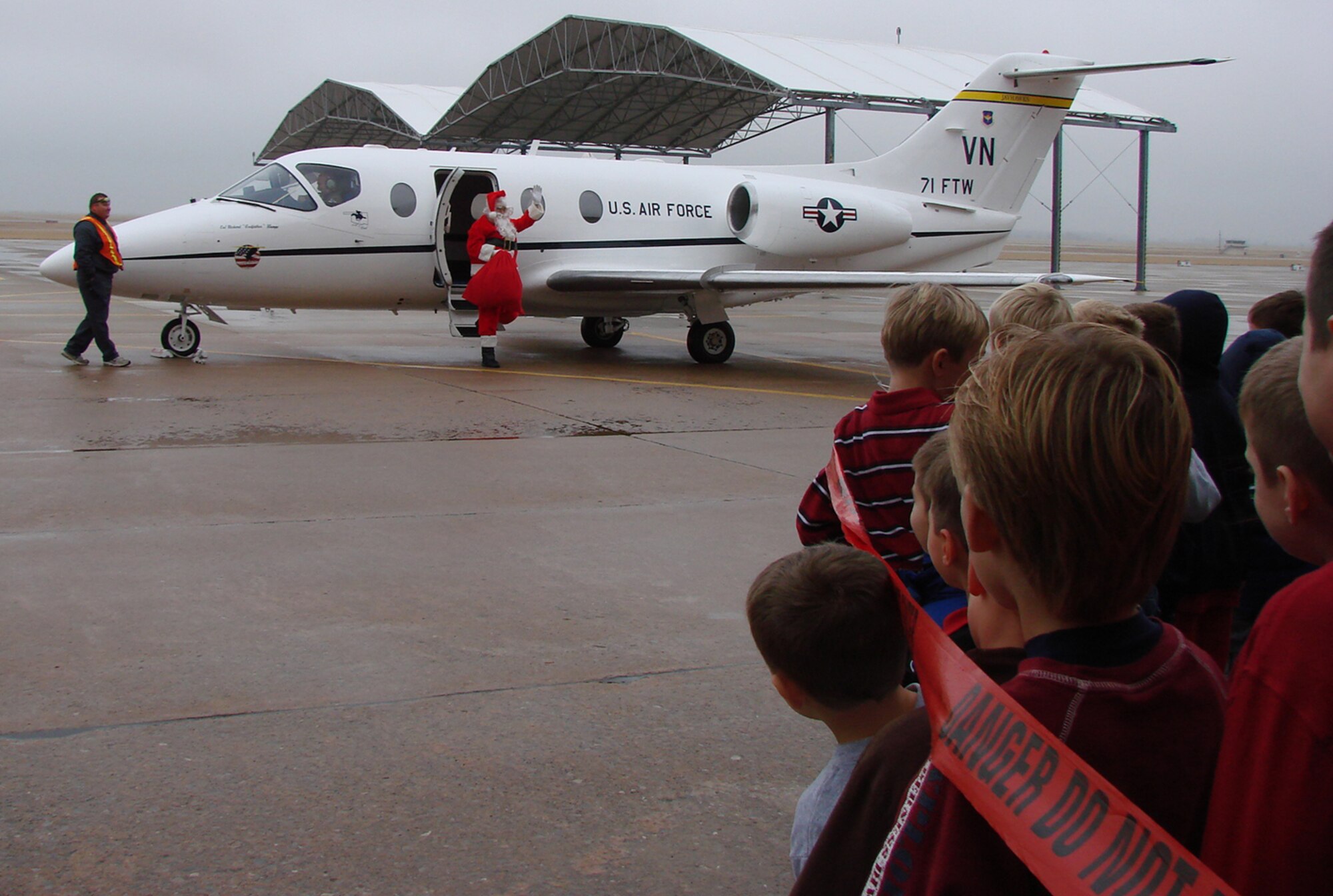Santa Claus flew in on a T-1A Jayhawk to meet a crowd of awaiting Team Vance members at Breakfast with Santa Dec. 8 in Hangar 170. The event featured food, games, holiday projects and a meeting with the jolly elf himself -- Santa! (U.S. Air Force photo by Tech. Sgt. Mary Davis)