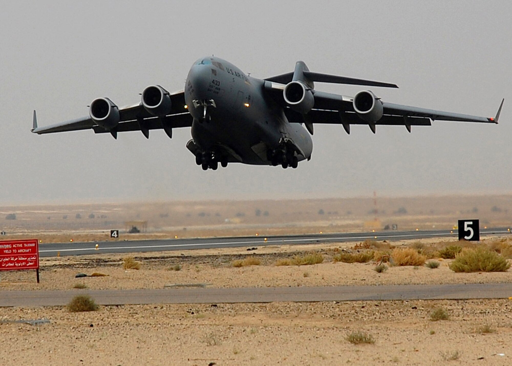 A C-17 Globemaster III takes off from an air base in Southwest Asia.  The C-17's primary mission is to transport servicemembers and cargo throughout the Middle East in support of operations Enduring Freedom and Iraqi Freedom.  (U.S Air Force photo/Staff Sgt. Tia Schroeder)