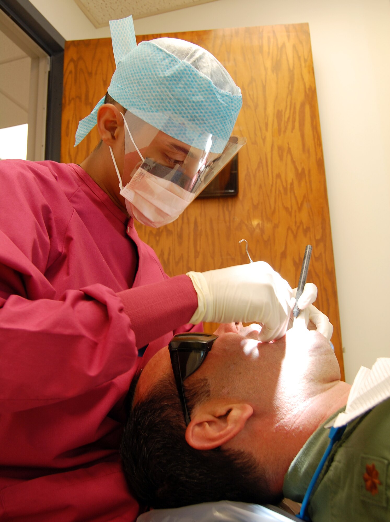 (Staff Sgt. Select) Jose Cardenas, 47th Aeromedical-Dental Squadron, perform a routine hygiene examination on a patient at the dental clinic here. The dental clinic emerged as the 2007 Air Education and Training Command outstanding small dental clinic during the recently announced annual AETC’s Medical Service Award winners. (U. S. Air Force photo/Airman Sara Csurilla)