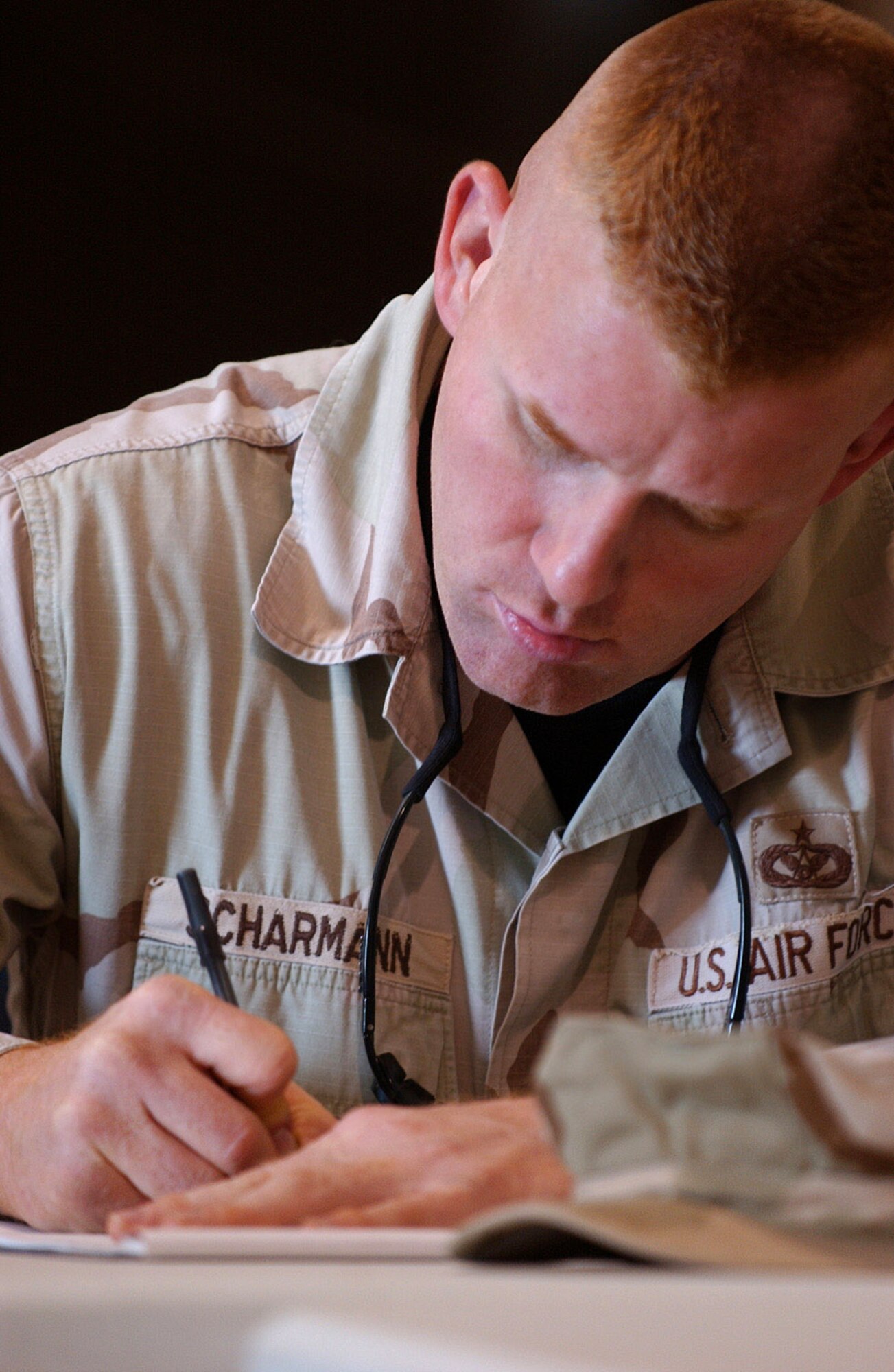 Staff Sgt. Jeffrey Scharmann takes notes during the Senior NCO Mentorship Seminar Dec. 8 at Ali Base, Iraq. The Top 3 Council hosted a Senior NCO Mentorship Seminar for mid-tier enlisted Airmen. Sergeant Scharmann is assigned to the 407th Expeditionary Civil Engineer Squadron and is deployed from Kadena Air Base, Japan. (U.S. Air Force photo/Airman 1st Class Jonathan Snyder) 
